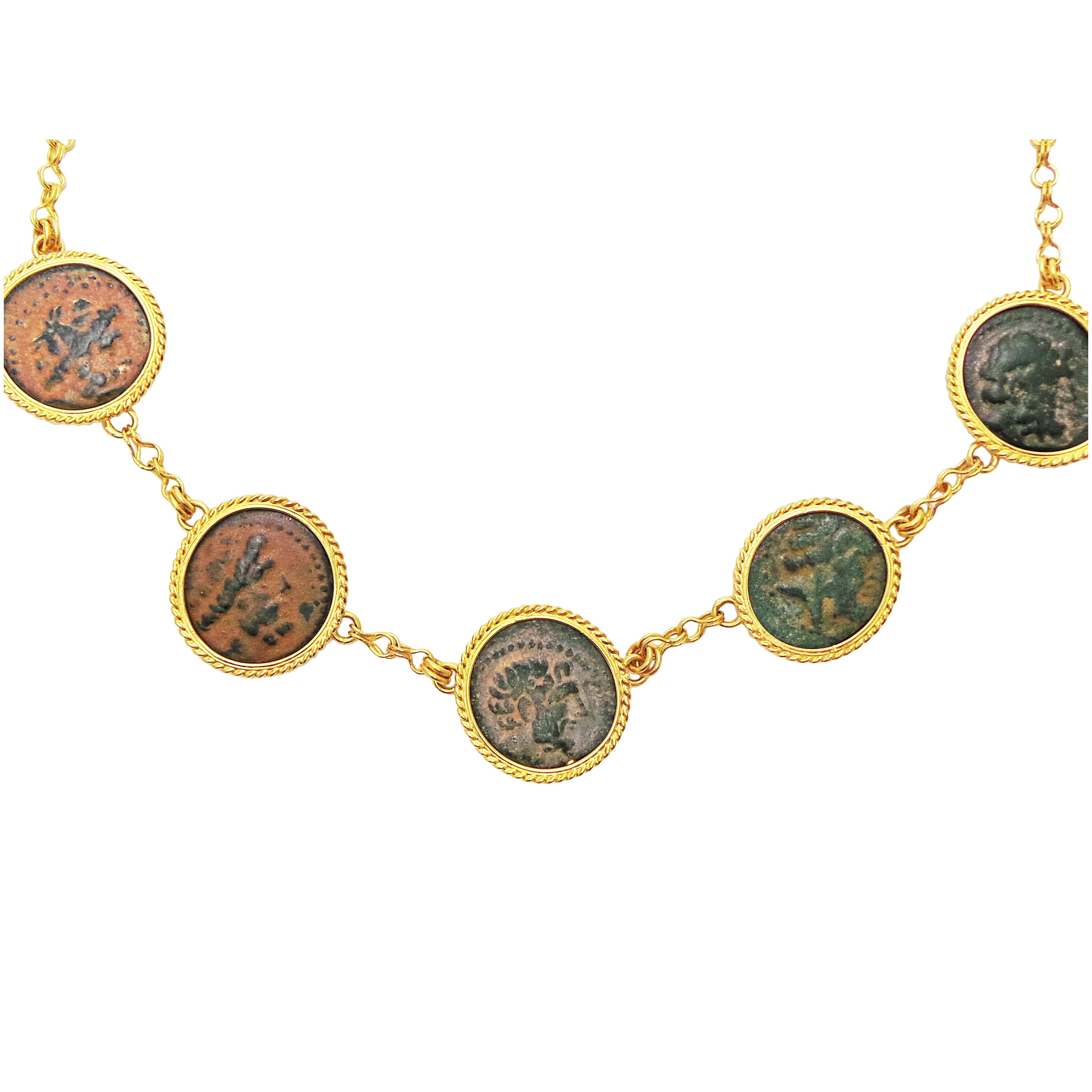 Five authentic ancient Hellenistic bronze coins (Arados in Phoenicia; 206-140 BC) set in 22k yellow gold rope bezels.  Each coin is set fixed in a 22k yellow handmade chain. Although these five coins are the same type of coin, they each have their