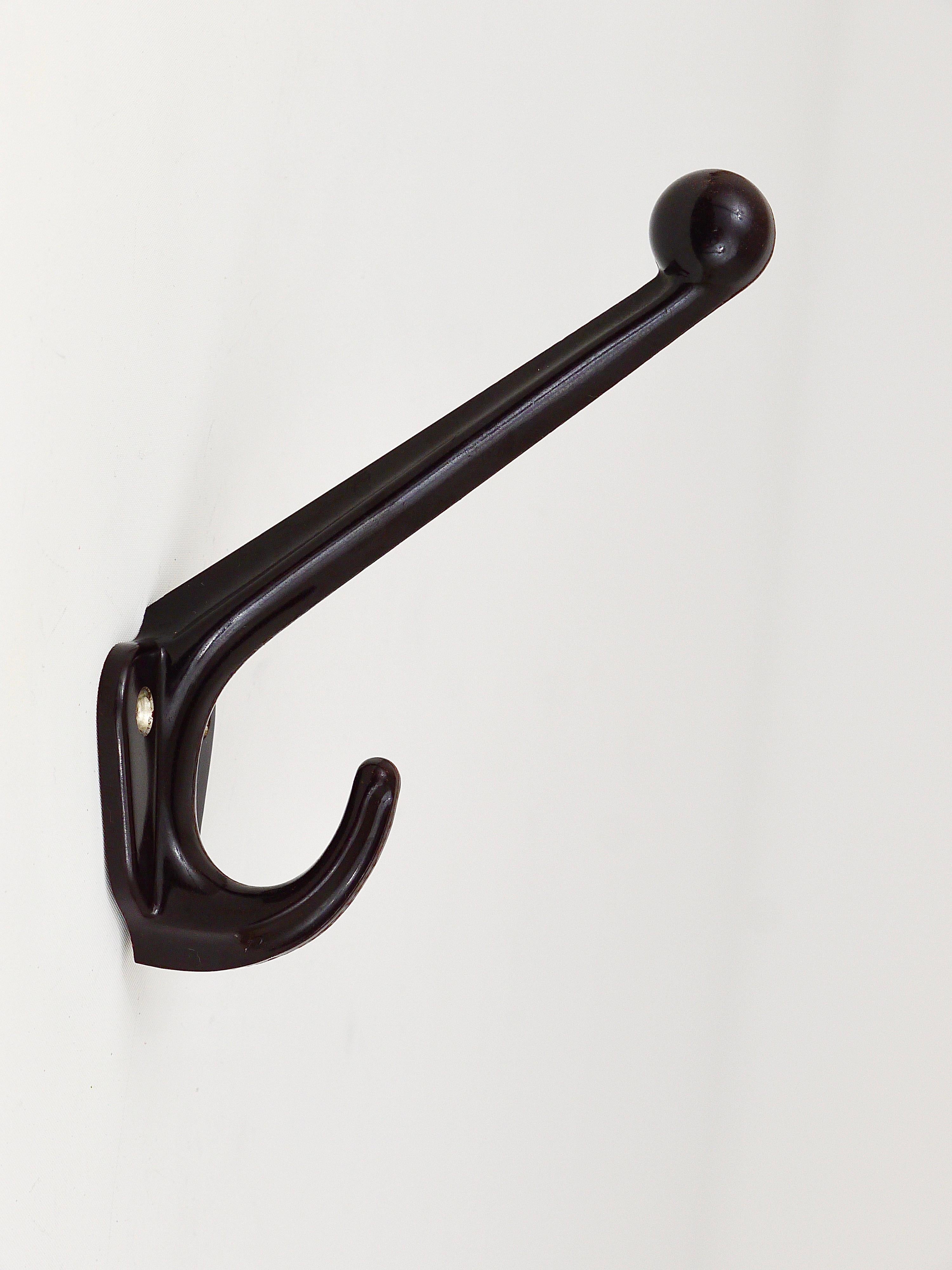 Up to five beautiful wall coat hooks, made of black/brown bakelite from the 1940s, made in Vienna/Austria. In very good condition. Five hooks are available, sold and priced per piece.