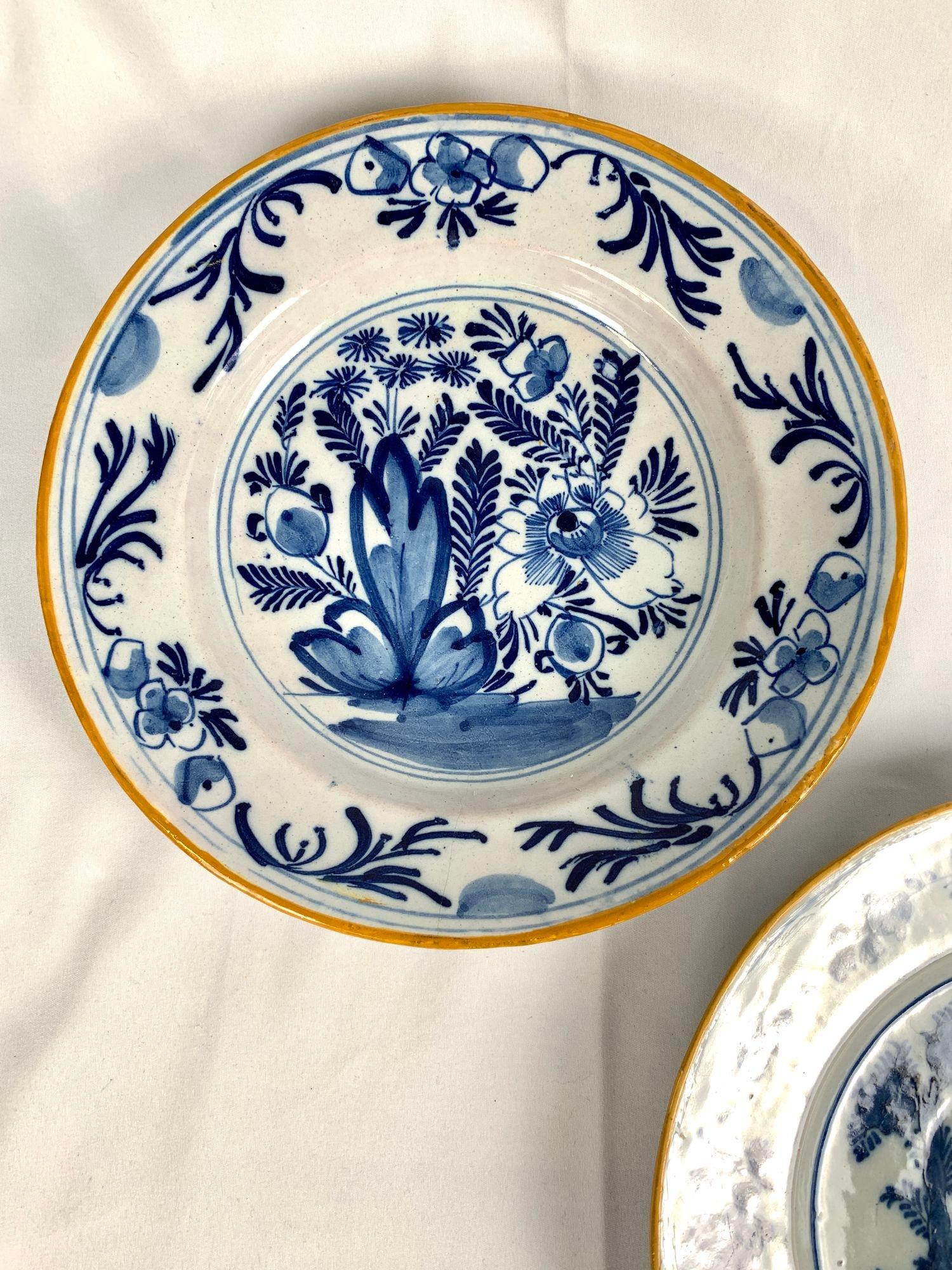 These five blue and white Delft plates were hand painted in the Netherlands, circa 1800.
The lovely plate in the center shows a deer resting in the forest.
The two pairs of plates around it show beautiful garden scenes with a traditional Dutch