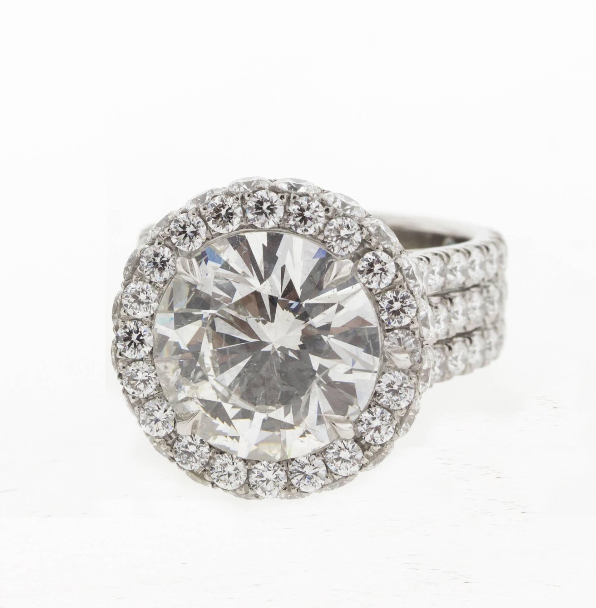 The center stone on this incredible 5 carat custom diamond ring is a sight to behold. An F color and a perfect round brilliant cut, the sheer size of this diamond mandated a custom setting be created with three shanks instead of the normal one or