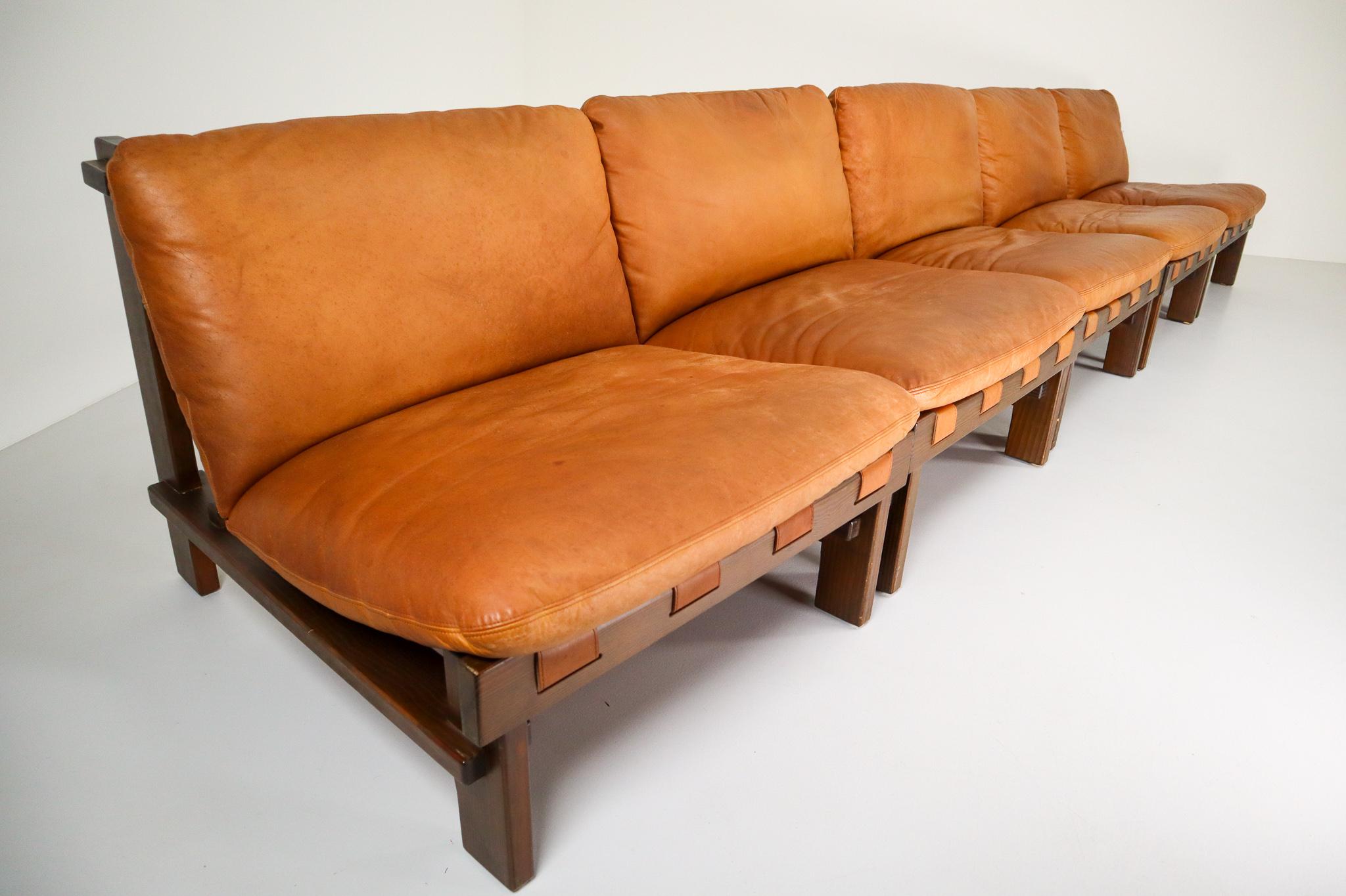 Pair of five lounge chairs by Carl Straub in absolutely gorgeous cognac leather and solid pinewood, circa 1960s. The the soft leather is beautifully patinated during use and age and. Altogether a lovely set that not only attracts attention by its