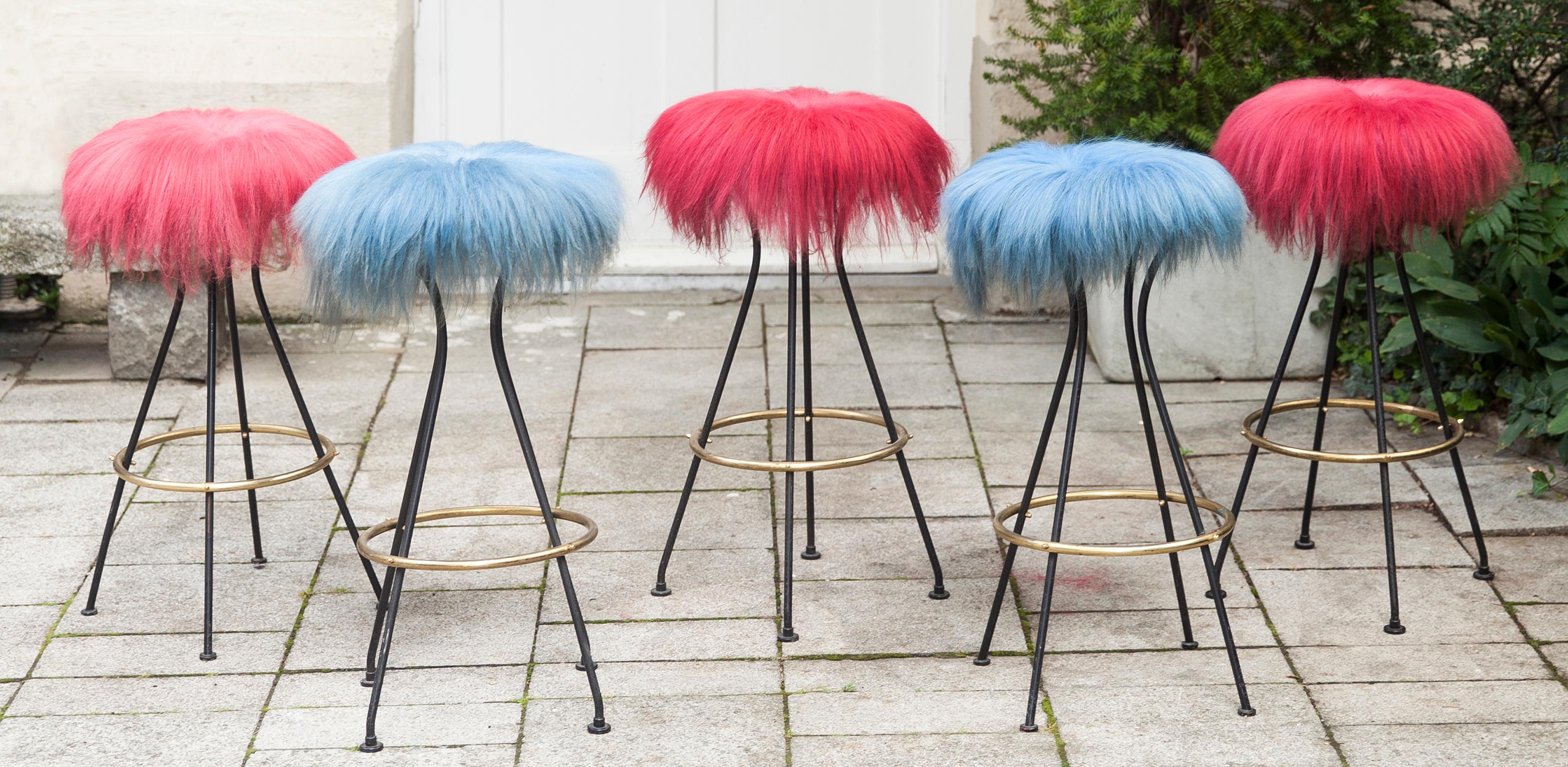 Funky bar stools in original red and blue colored lambskin top with black metal base and a brass ring.
 