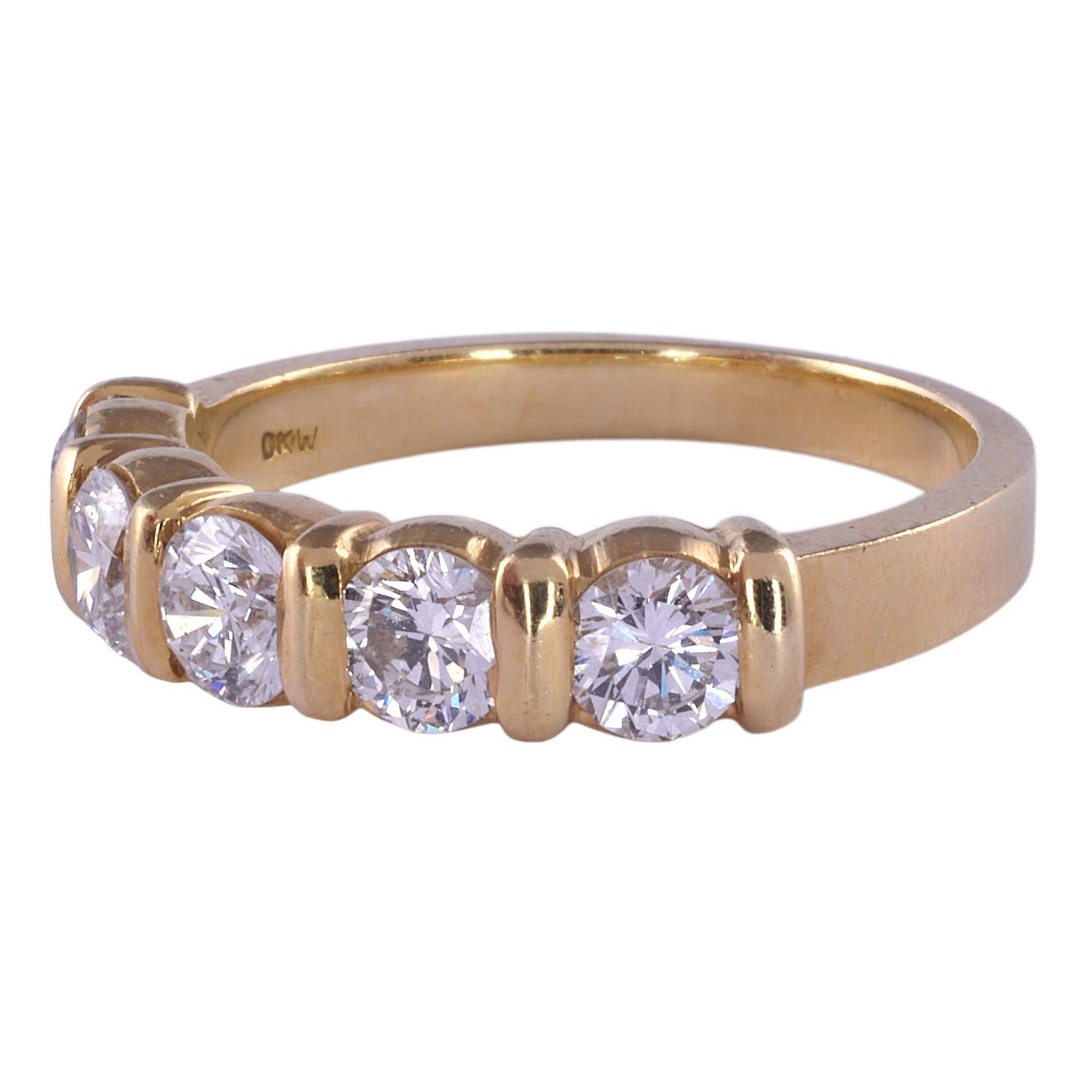 Estate five diamond 18K gold band. This band style ring is crafted in 18 karat yellow gold and features five diamonds at .90 carat total weight. The diamonds have SI1-2 clarity and H-I color. This diamond band is a size 5.75. [KIMH 2930