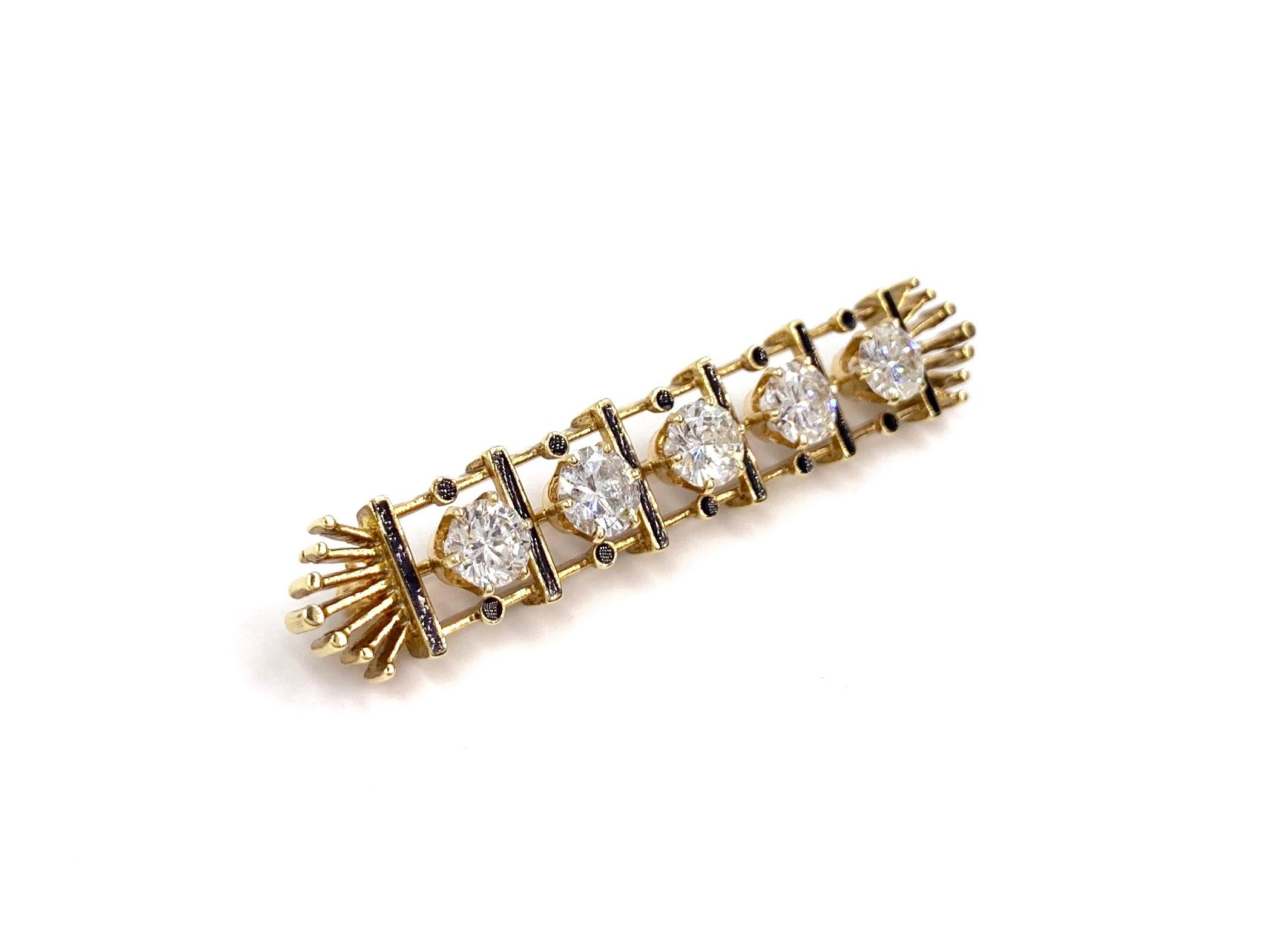 A timeless and well made 14 karat yellow gold and black enamel bar brooch featuring five round brilliant diamonds at 2.89 carats total weight. Diamond quality is approximately G color, SI1-SI2 clarity with a generous amount of brilliance and