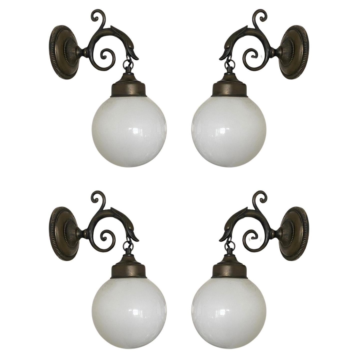 Five lovely bronzed brass bird wall sconces with opaline glass ball globes, for indoor and outdoor use, France, 1930-1939.
The wall sconces are in very good condition, beautiful patina to brass, fully functional. Each sconce takes one 
Edison E14