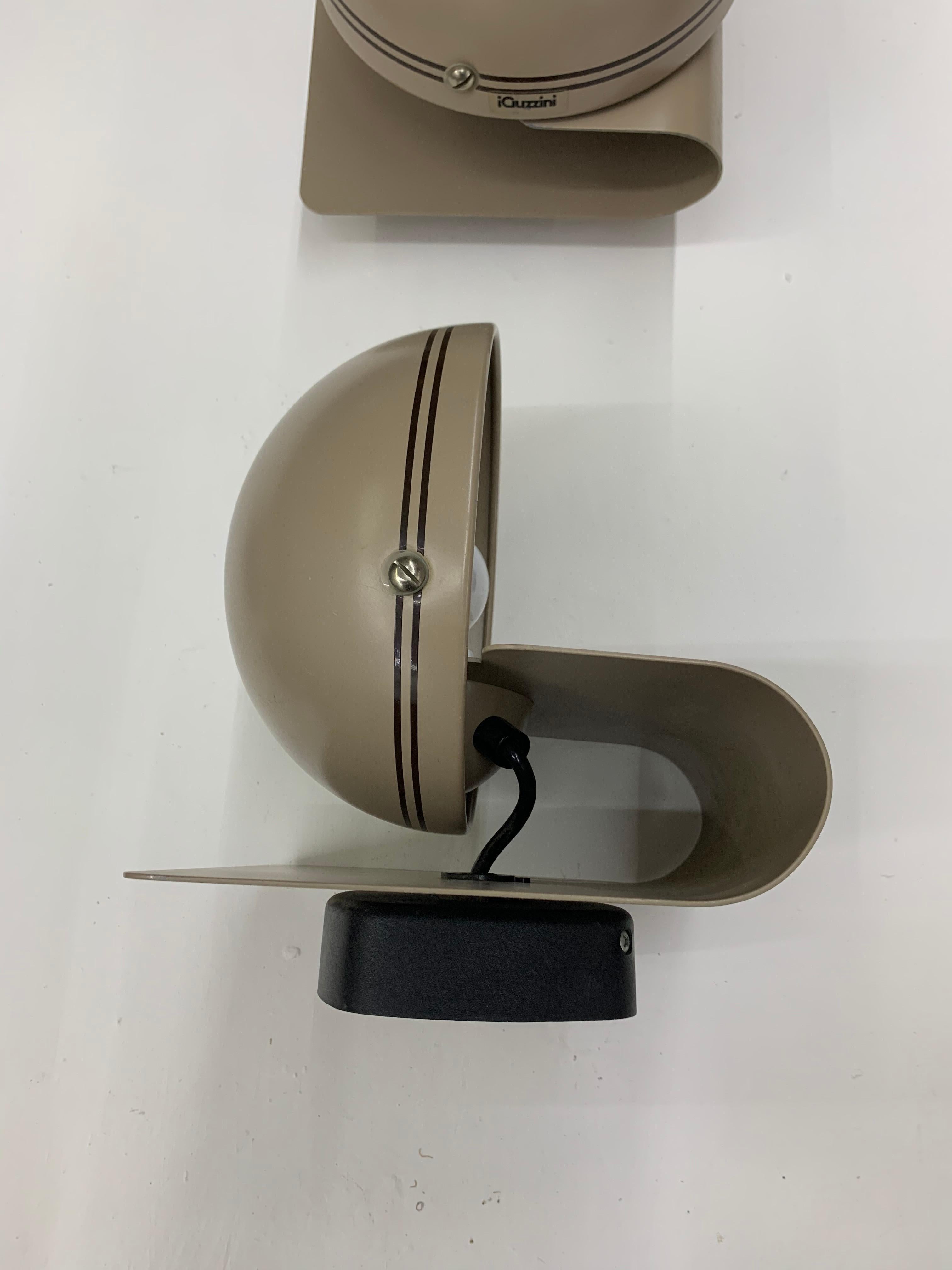 Five wall lights or sconces designed by Harvey Guzzini and manufactured by iGuzzini in Italy, circa 1960
Both the shade and the main body swivel to create different lighting angles and shadows.
Most of them hold their original labels.
Priced