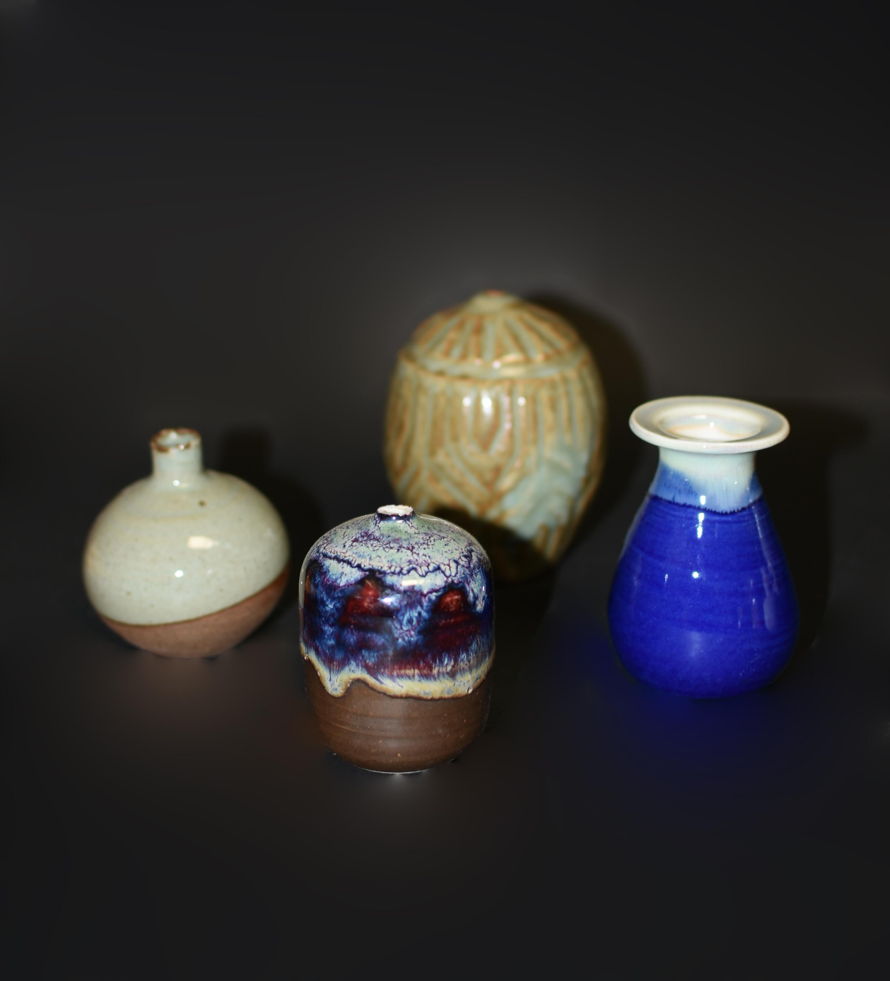 A collection of 5 small Japanese wabi sabi glazed pottery vases in beautiful blue, mottled green, celadon, and polychrome dripped glaze. The Japanese wabi sabi methodology celebrates life's natural occurrence. It honors genuine force of nature