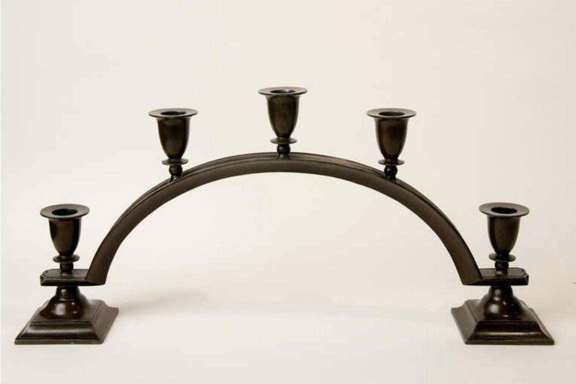 Patinated diskometal five-light candelabrum, stamped with Andersen’s mark on the underside of both square bases, model 158.

