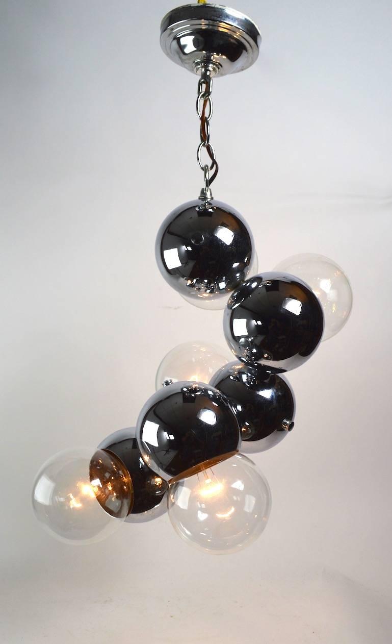 Modernist chrome ball hanging fixture, in very fine original, working condition.
Diameter of chrome ball without bulb 5 inch, accepts standard screw in incandescent bulbs. Height of fixture (24 inch) does not include chain and canopy.
The five