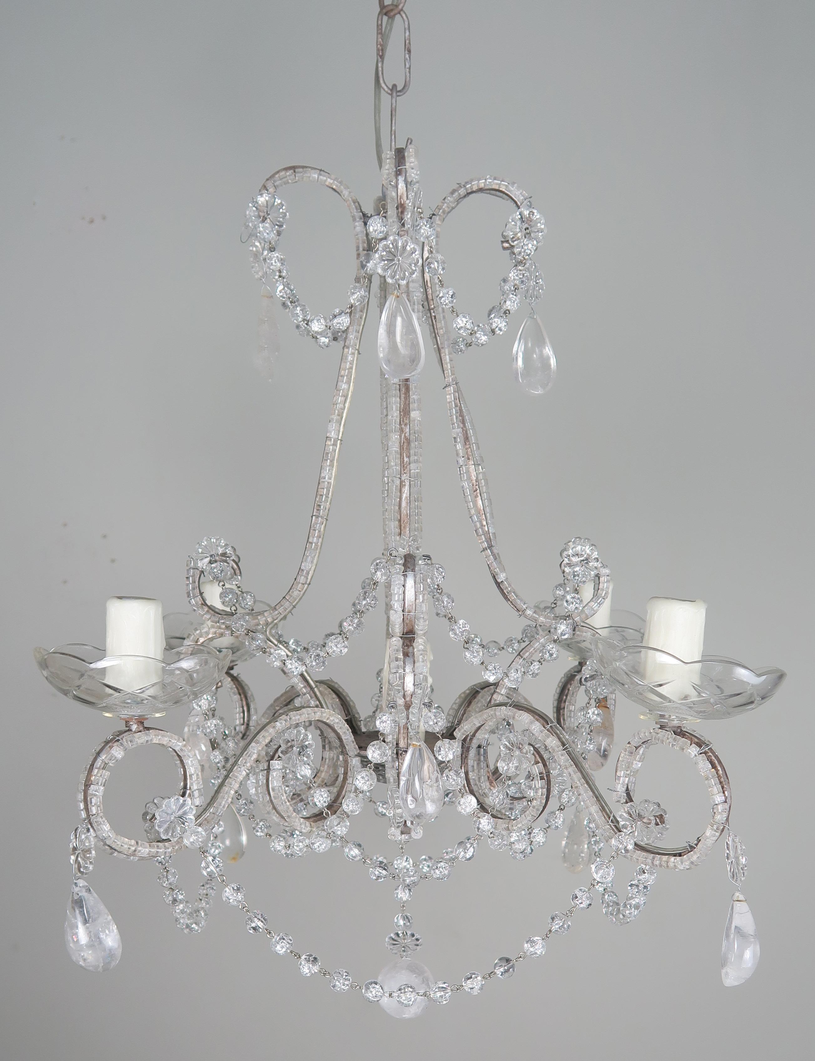 Crystal five-light rock crystal chandelier with garlands of crystal beads and almond shaped rock crystals throughout. Rock crystal ball at bottom. This fixture is newly rewired with drip wax candle covers. Includes both chain and canopy.