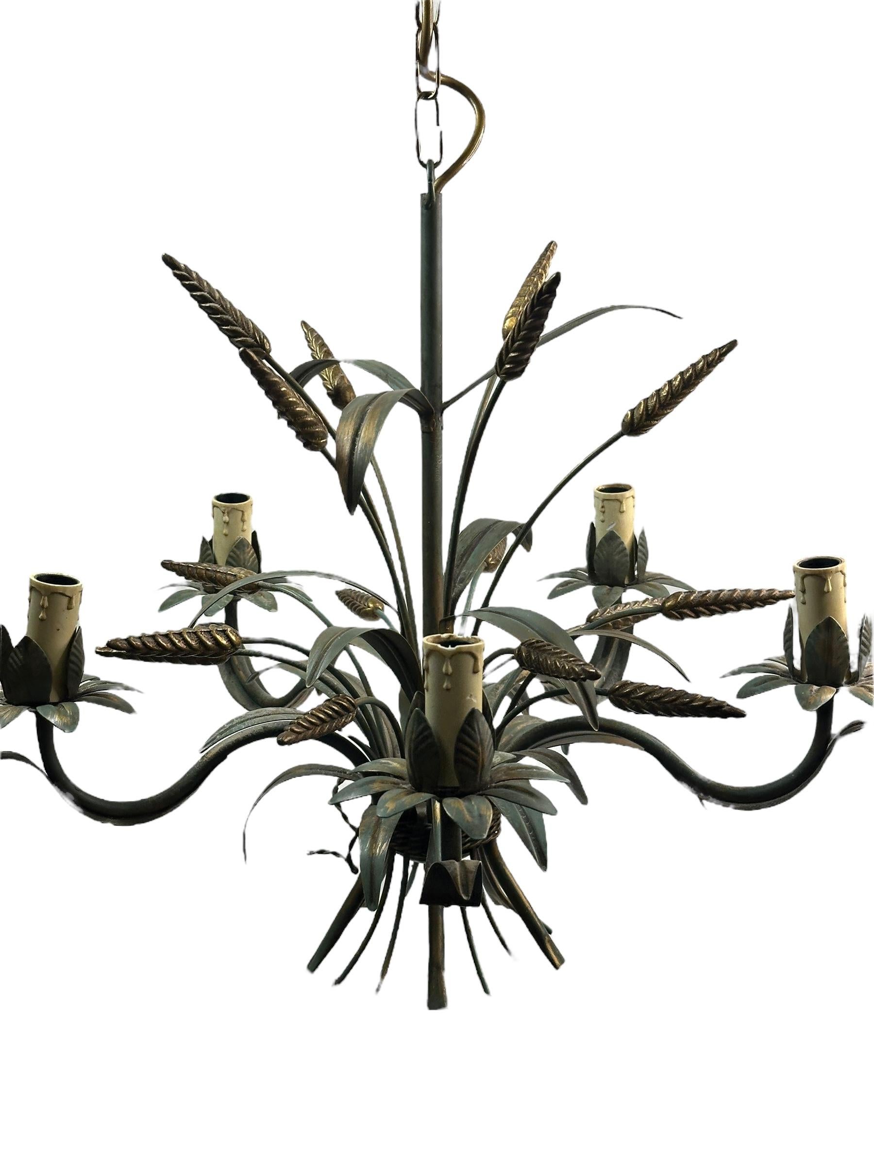 A Hollywood Regency midcentury gilt verdigris tole wheat sheaf chandelier in Coco Chanel Style, the fixture requires five European E14 candelabra bulbs, each bulb up to 40 watts. This light has a beautiful patina and gives each room an eclectic