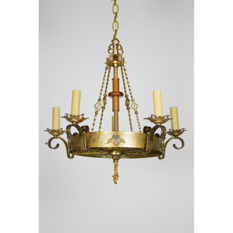 Five light gothic revival chandelier. Lights extend from a ring, central stem and twisted solid rods holding the ring. Filligree design on bottom of ring. Bakelite accent pieces in stem, original paint on shields, brassy gold metal finish. American,