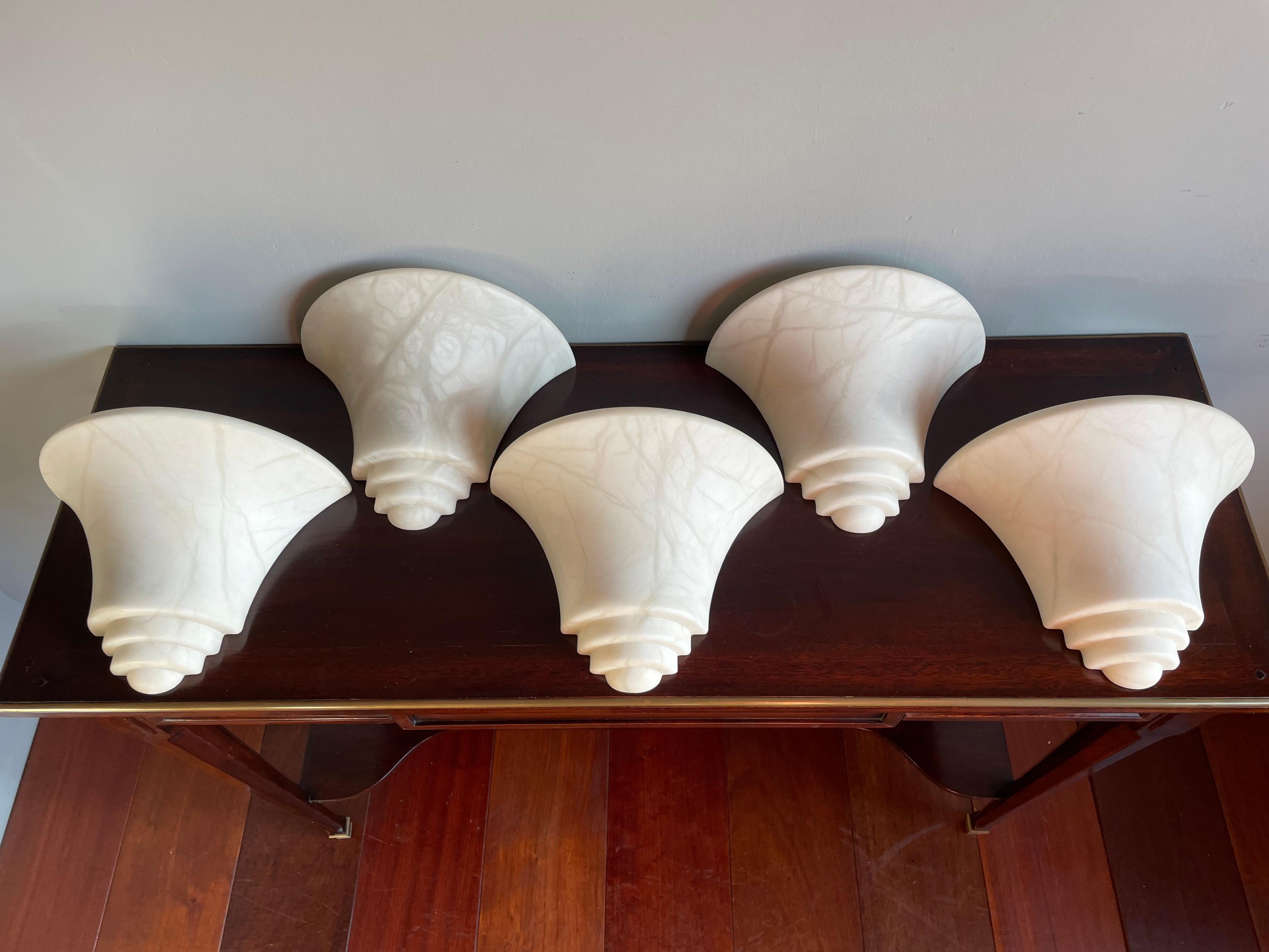 Timeless set of 5 alabaster wall lights for creating the perfect atmosphere.

These good size and great design wall sconces with warm light creating qualities are all in mint condition. There is something about the look and feel of these alabaster