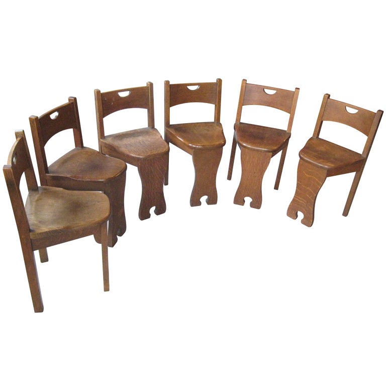 Made entirely of thick quarter-sawn oak, these little beauties are both sculptural and functional. Beautifully rounded seats; lovely cutouts on the backrest and front foot. The seat is dining chair height, but the backrest is very low.