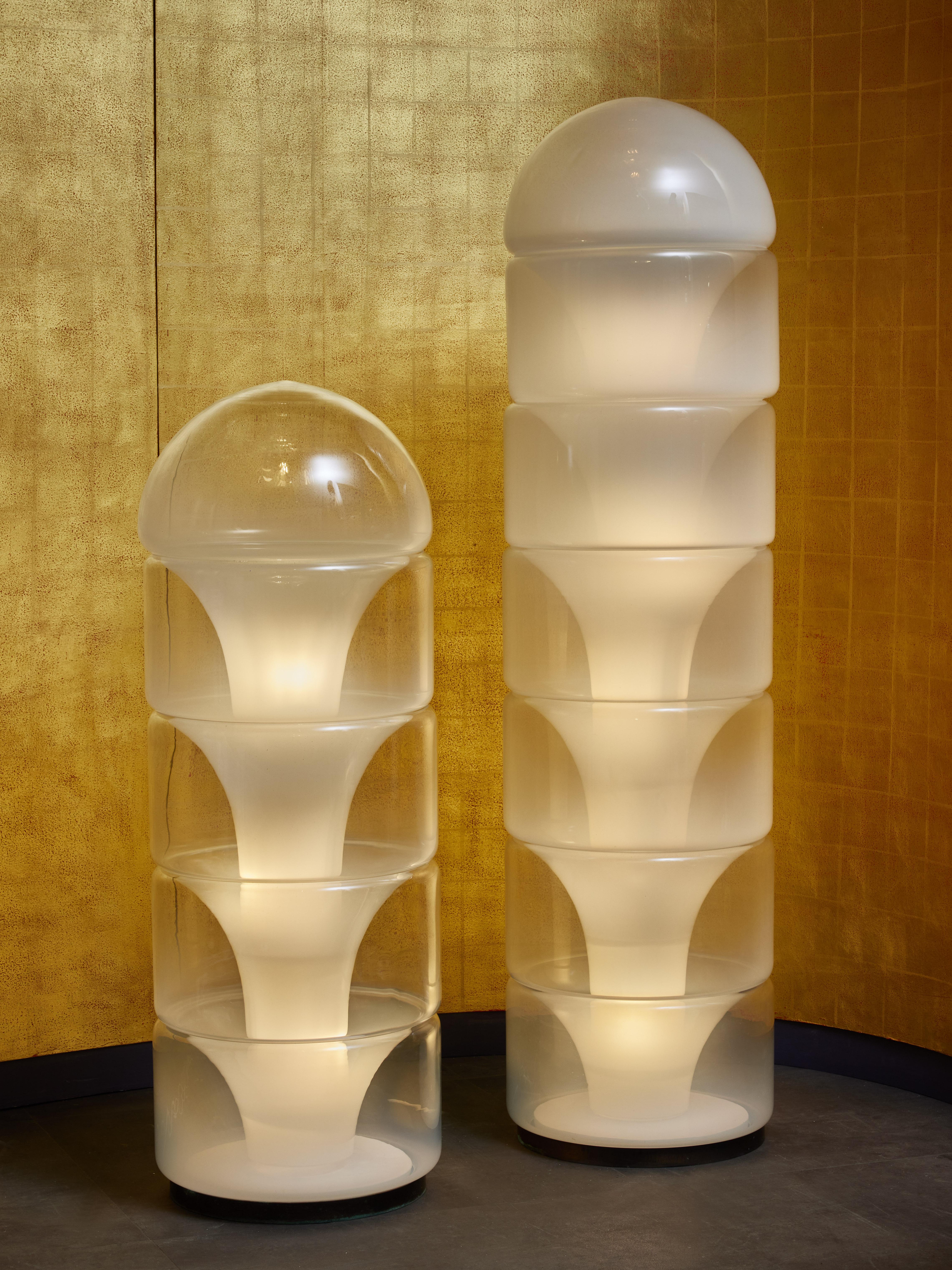 Sfumato glass floor lamp designed by Carlo Nason for Mazzega.

This piece (pictured on the left) is made of a metal inner structure on which is stacked five Murano glass elements spreading the light.