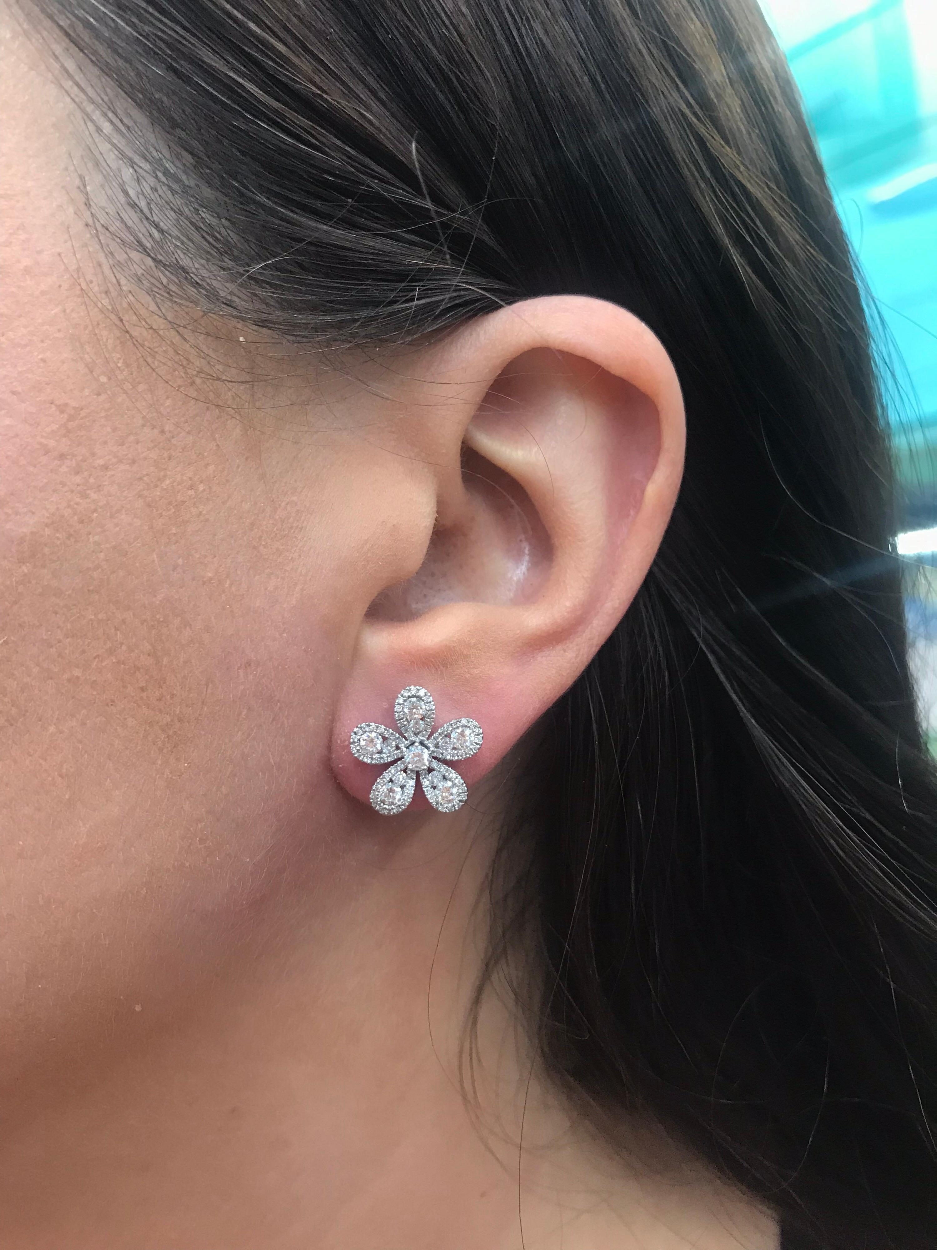 18K White gold flower earrings featuring 5 diamond petals of round brilliants weighing 1.36 carats. 
Color G
Clarity VS