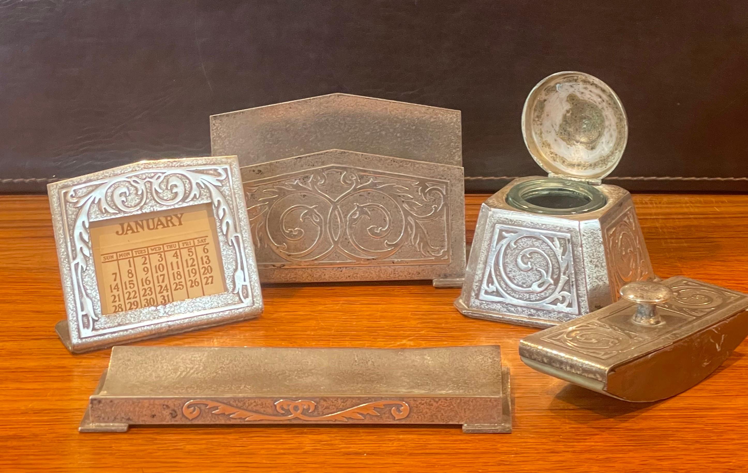 A very nice five piece Art Deco desk set in sterling silver coated bronze by Silver Crest Bronze Co., circa 1930s. The set is in good vintage condition with a wonderful patina and includes: ink weel, blotter, adjustable calendar, letter holder and