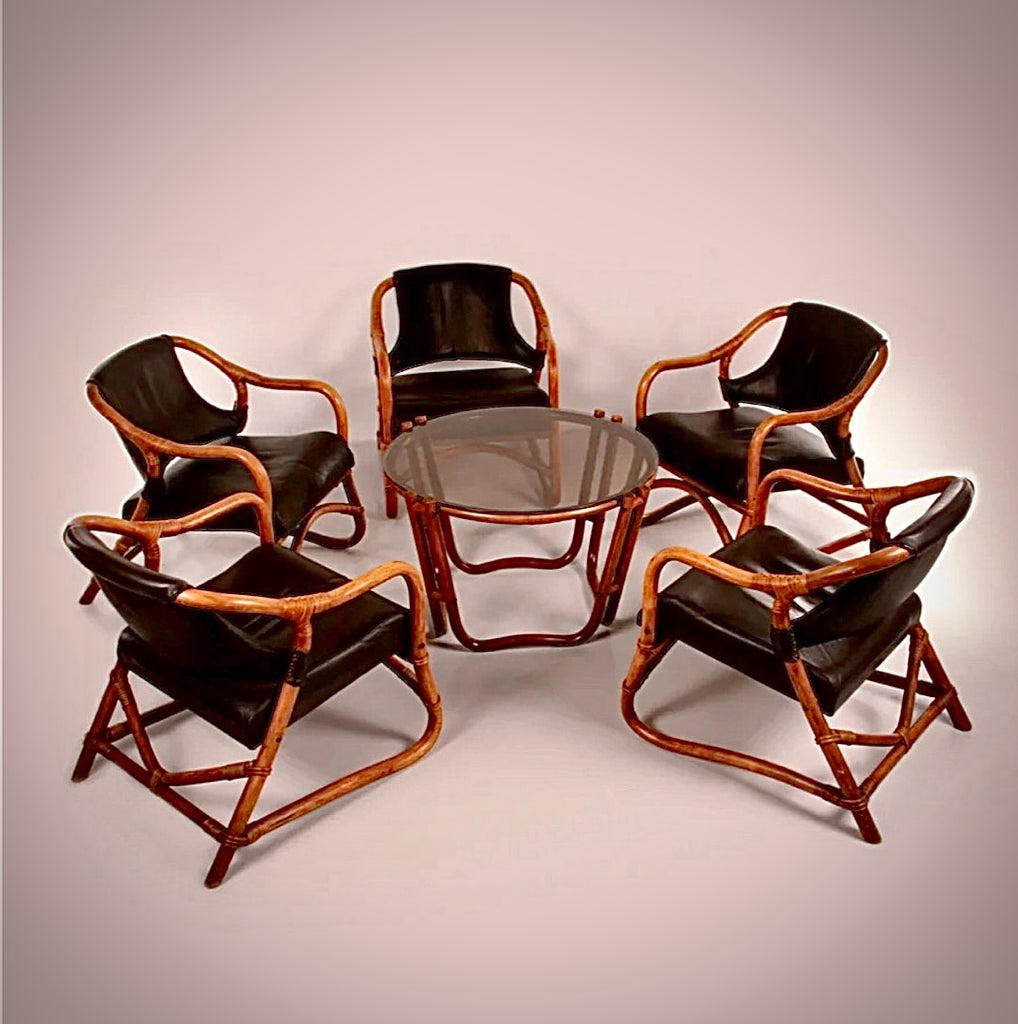 Dutch midcentury bamboo salon set with five upholstered black leather armchairs and circular glass-top coffee table. Handsome yet relaxed, with a warm, soft patina and beautifully contoured lines. 

Netherlands, circa 1960

Dimensions: 24.4W x