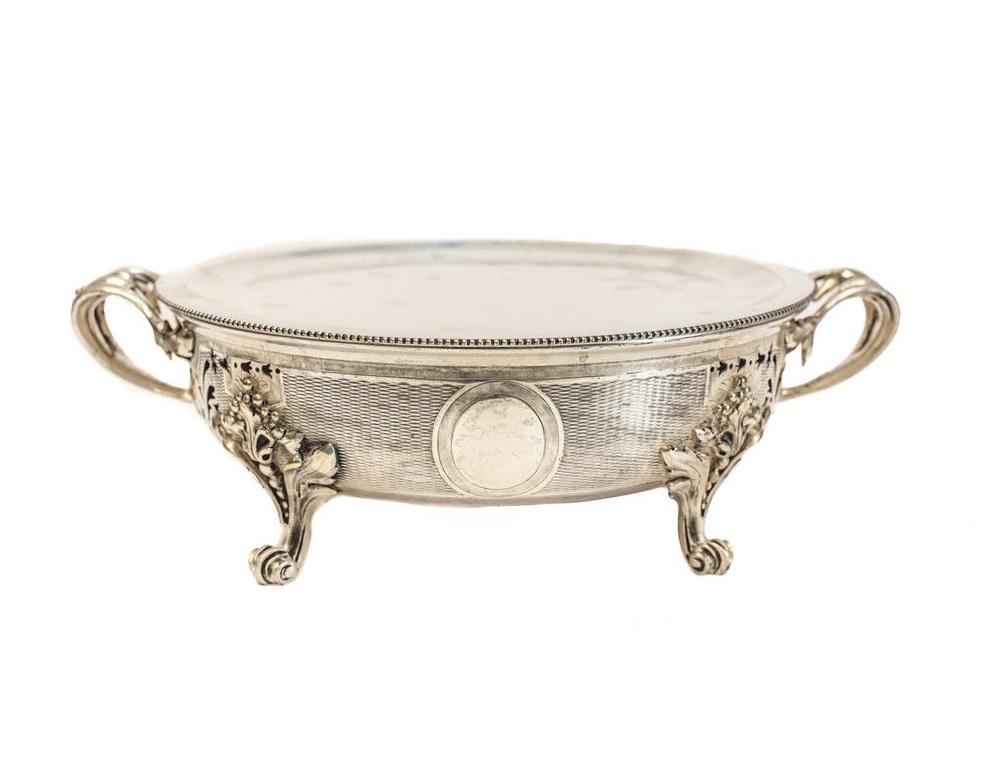 Five-piece Christofle silver plate dish warmer, circa 1940. Hand chased foliate scrolls to the double handles. Open monogram to the center. Marked to the underside. Comes with four round dish warmers and one oval dish warmer. 

Measures