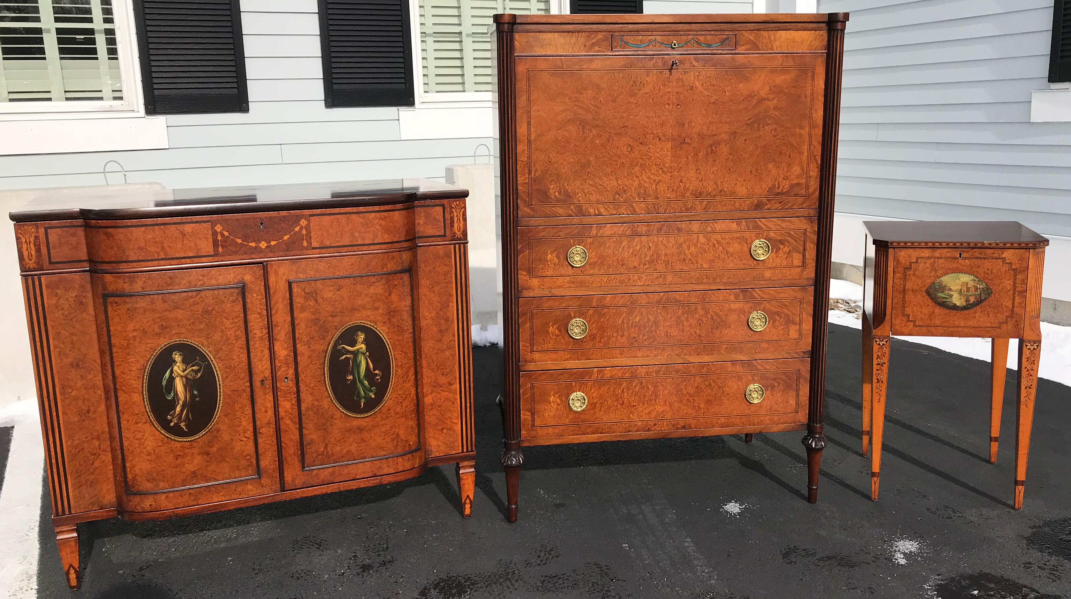 A beautiful five-piece custom mahogany and burled walnut veneered bedroom set including two twin beds, tall chest, low chest, nightstand, and hand painted mirror. The pieces feature a variety of swag, banded, and diamond inlay, carved scroll
