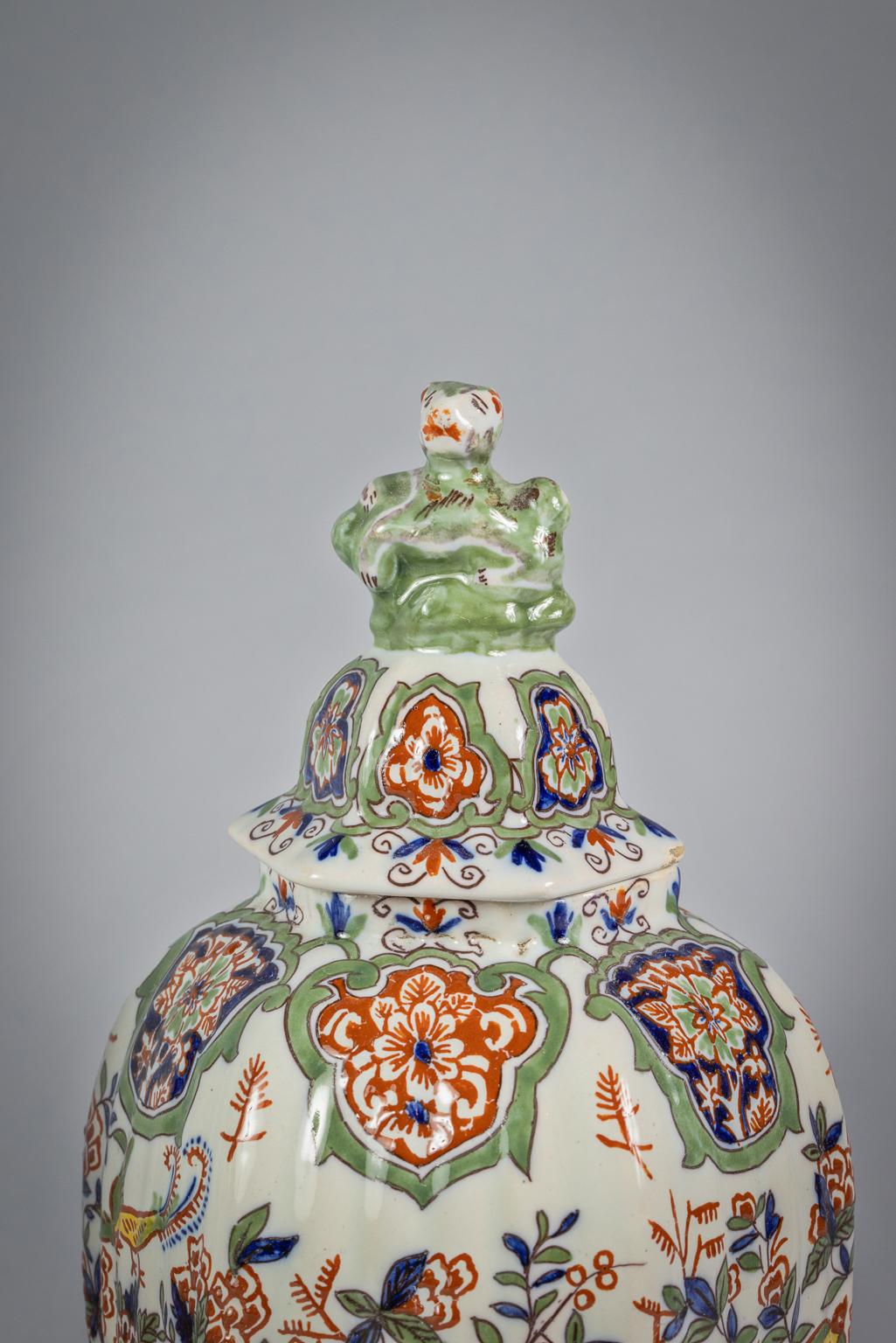 Each vase painted around the ribbed hexagonal exterior with birds amidst flowering oriental plants between floral cartouche borders, comprising: three ovoid vases and covers and two beaker vases, LF monogram marks painted in red.