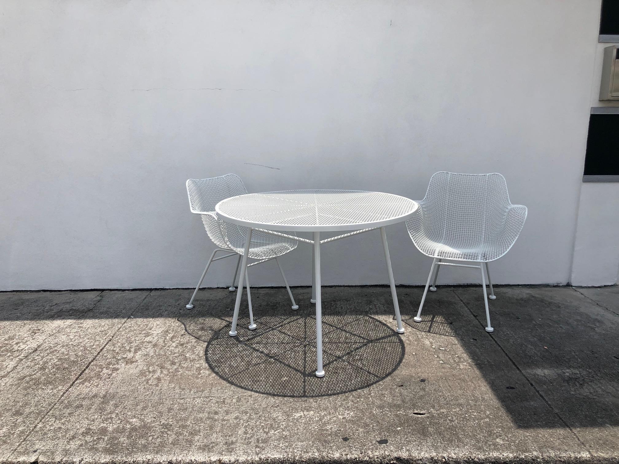 This stylish five piece set of Mid-Century Modern patio furniture was designed by Russell Woodard and is known as the 
