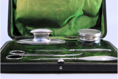 Five-piece silver manicure set with hard case and green velvet interior