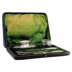Five-piece silver manicure set with hard case and green velvet interior