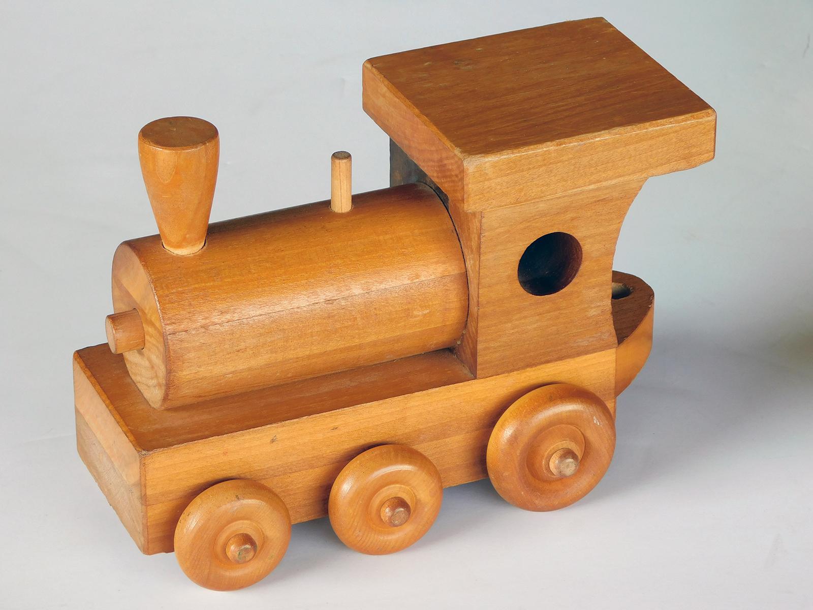 This whimsical train set consisting of five interlocking pieces: locomotive, tank car, hopper, coal car and the caboose; wheels work smoothly.