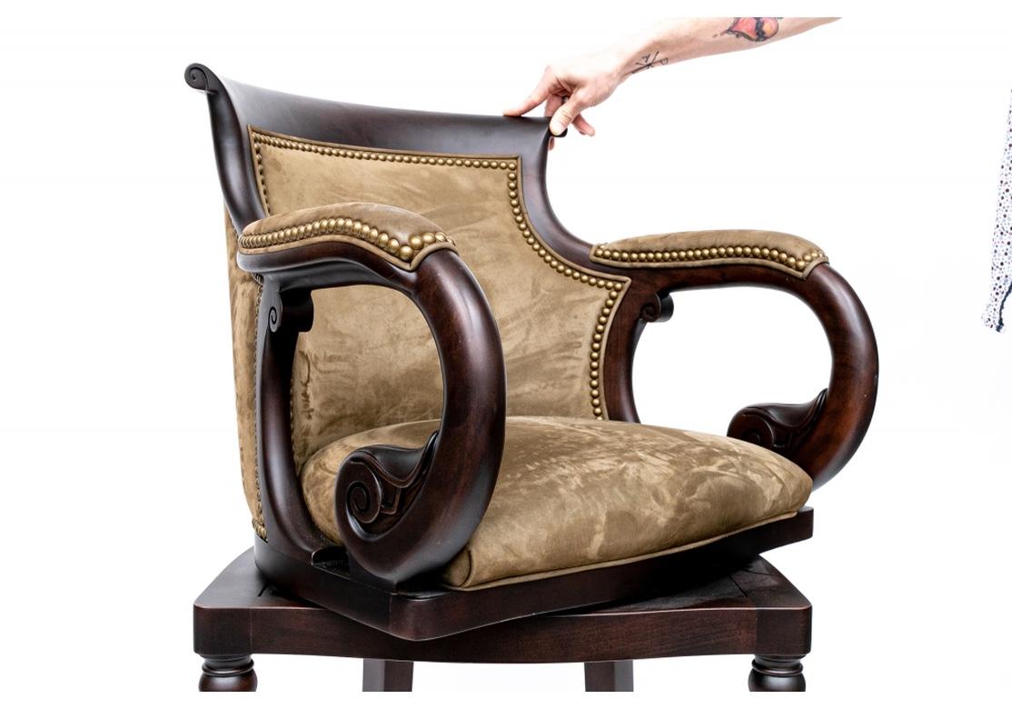 Set of five Hancock & Moore swivel bar stools displaying a rich wooden finish featuring carved inlays throughout, and showcasing a leather upholstered seat and back with nail-head trim. With elegantly curved backs, and leading down to ornately