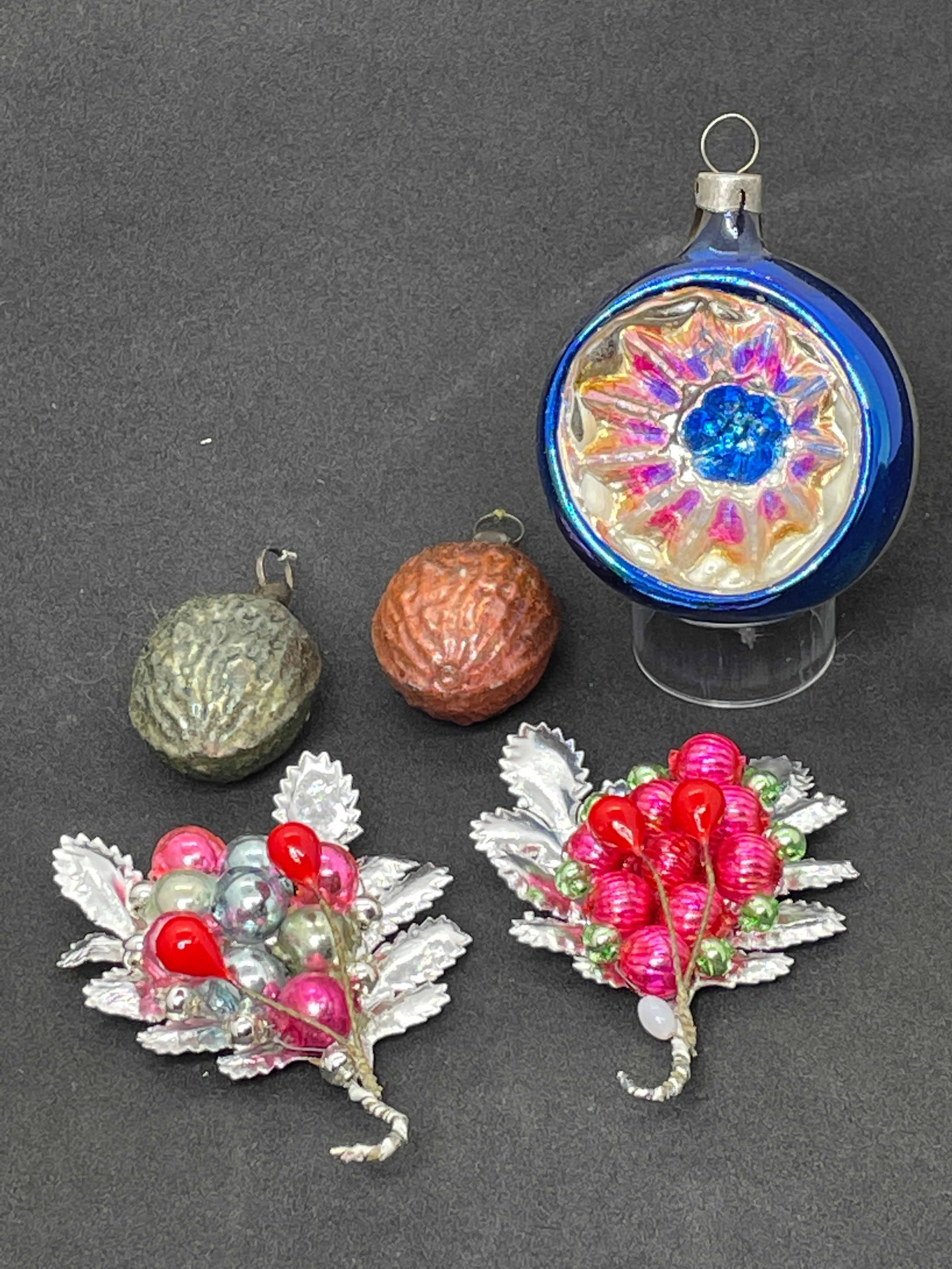 A rare set of 5 Christmas ornaments. Each is made from thin mouth blown glass, this would be a great antique addition for your Christmas or feather tree. Included is a nice Reflector ornament from the 1930s, 2 small walnut feather tree ornaments