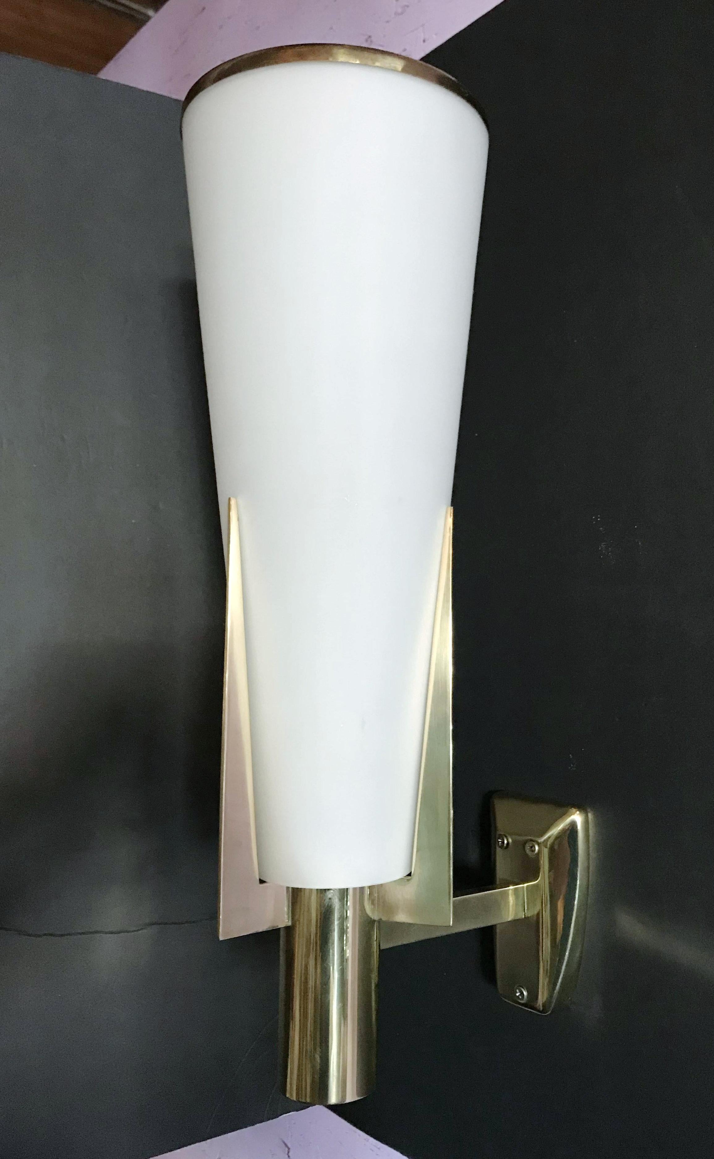 Rare original Stilnovo wall lights model 2021/1, frosted tapered conical glass shades held by polished brass structure, some have original stickers / Made in Milan Italy in 1960s
Measures: Height 20 inches / width 6 inches / depth 8 inches
1 light /