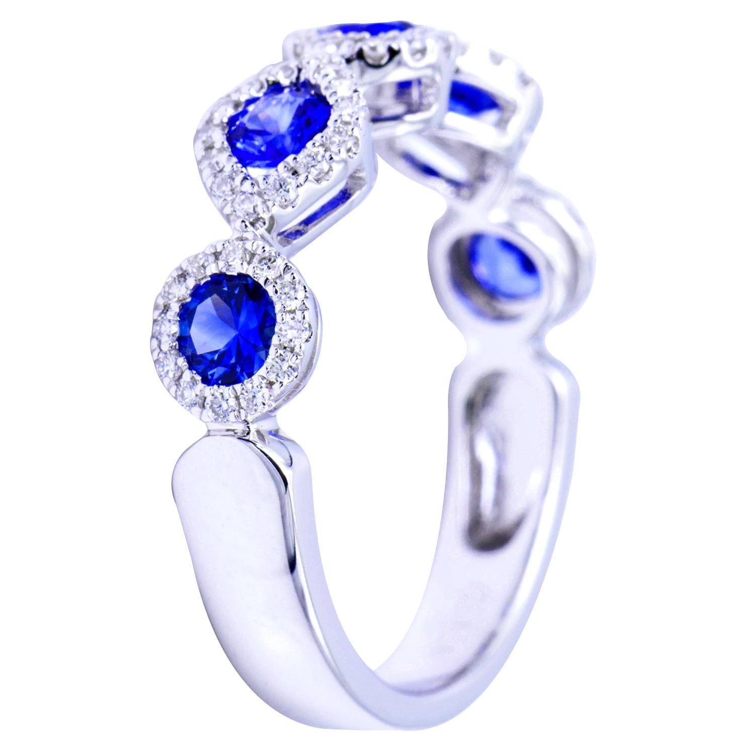 This gorgeous ring has 5 beautiful blue sapphires totaling 0.81 carats, Each sapphire is surrounded with VS2, G color diamonds. There is a total of 64 diamonds making up 0.25 carats. The stones are set in 3.5 grams of 18 karat white gold. This ring