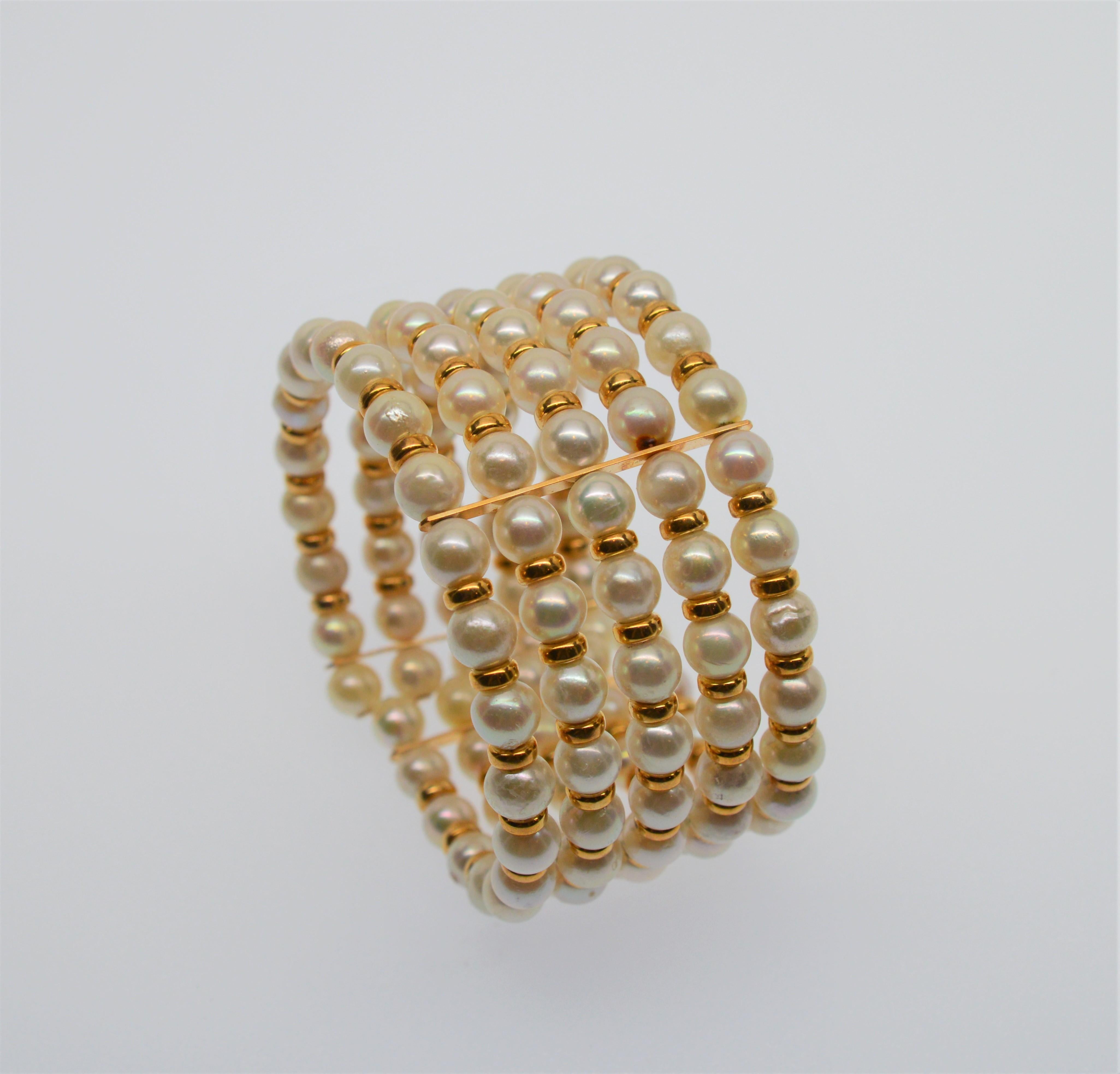 Five Row Akoya Pearl Expandable Cuff Bracelet with 14 Karat Findings. 
Multiple Rows of 6mm AAA Creamy White Akoya Pearls strung with alternating 14 Karat Gold Beads
make this piece pop. Flexible cuff to fit most. Measures approximately 1 1/4