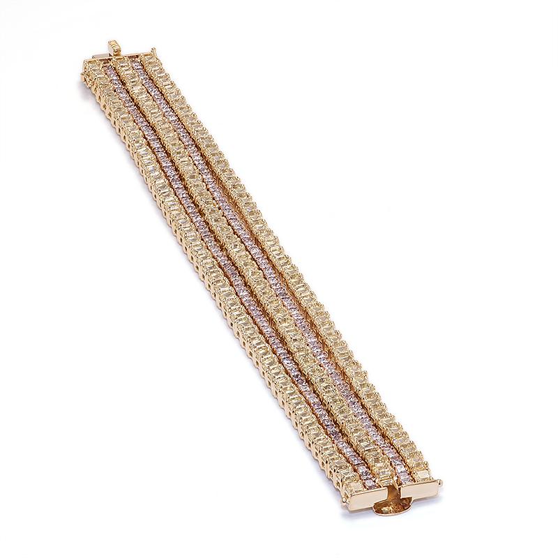 Dazzle them all with this incredible five row diamond bracelet featuring over 300 natural fancy yellow and pink diamonds. Each row is free to move and catch the light on your wrist as they are all connected at the end by a rose gold push clasp.