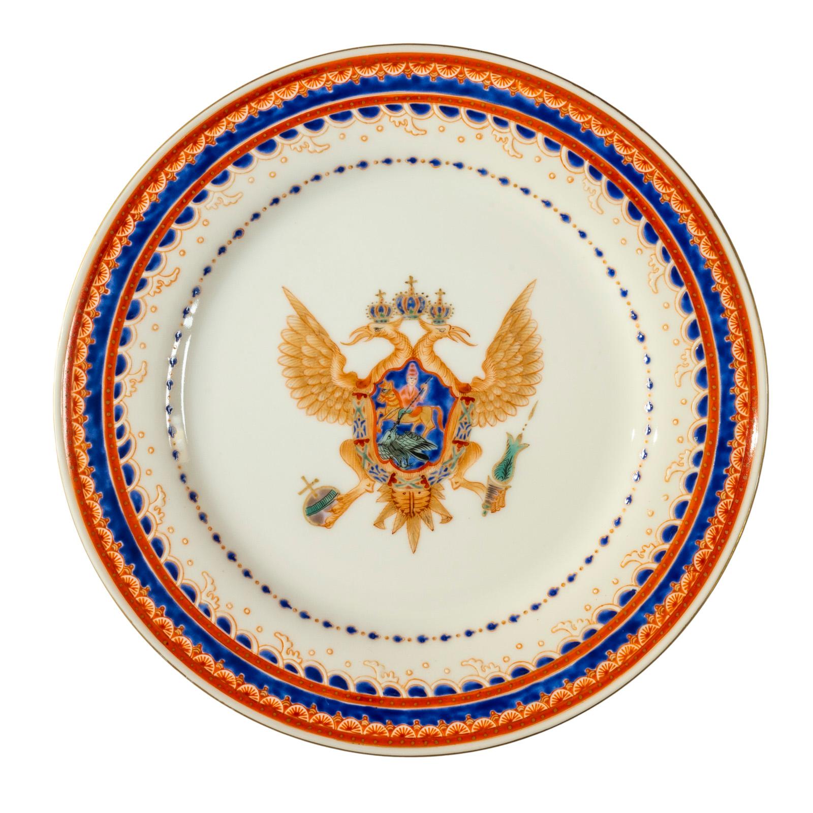 Colorful and festive dessert plates each decorated with an imperial Russian double headed eagle in the center, enclosing a deep blue shield of St. George Slaying the Dragon, the symbol of Moscow, Russia's ancient capital. The outer border features