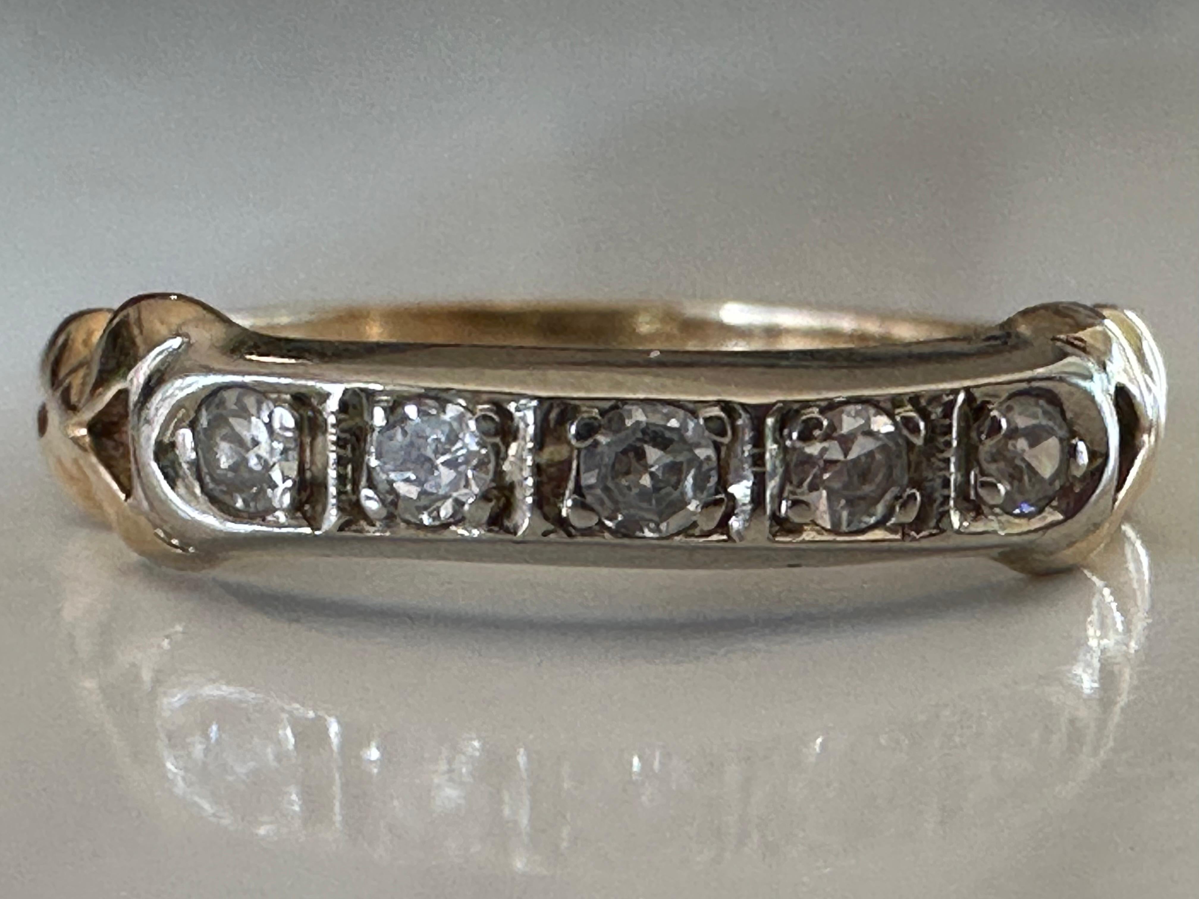 Five single-cut diamonds, together weighing approximately 0.05 carats, F color, SI clarity, sparkle shoulder-to-shoulder in this classic and lovely band ring, hand fabricated in two-tone 14K gold. 



