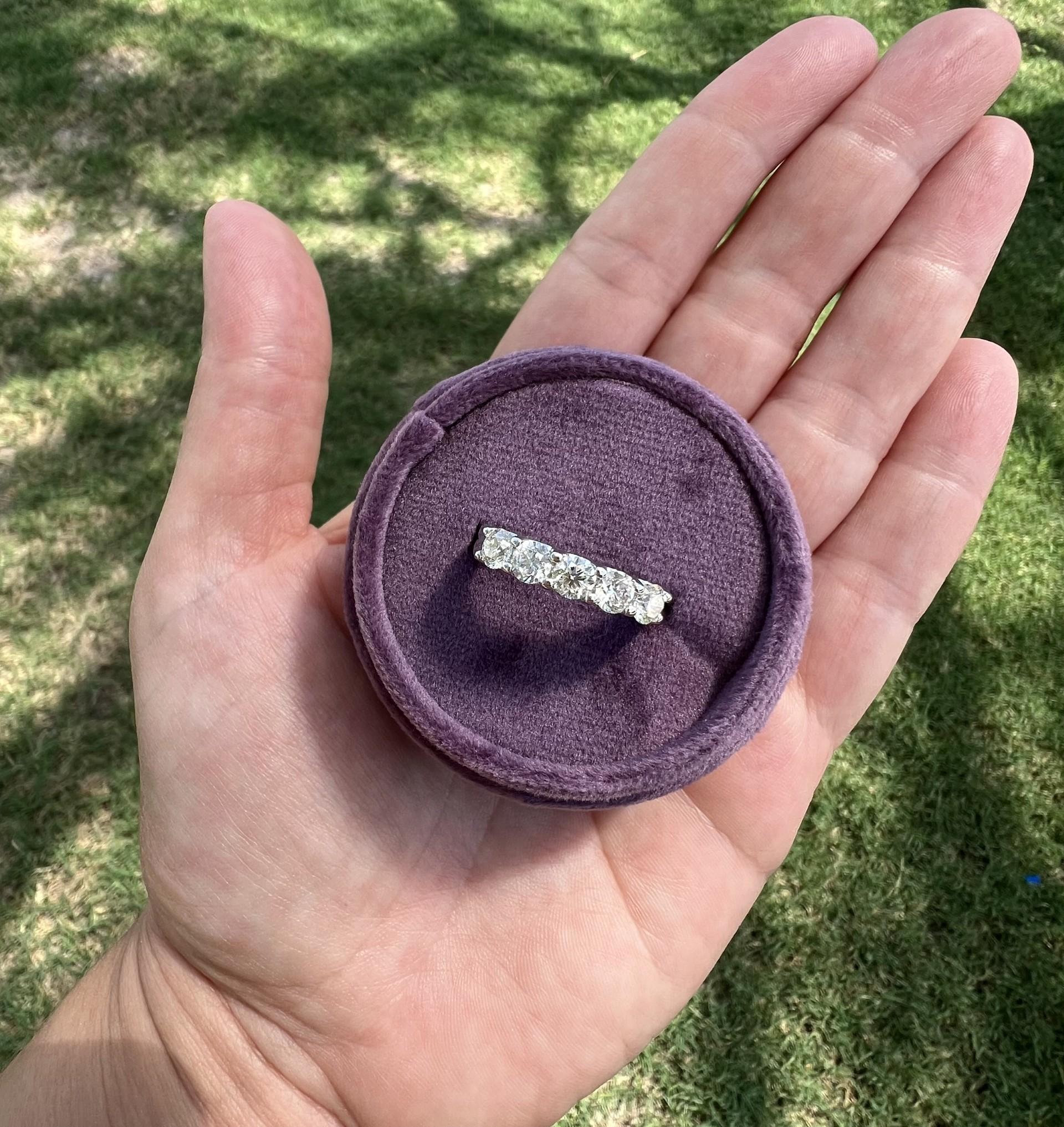 This exquisite 5-stone round diamond anniversary band is crafted in radiant 14k white gold. Each diamond is meticulously set in a shared prong setting, ensuring maximum light exposure and brilliance, and totaling 1.47 carats. The band features five