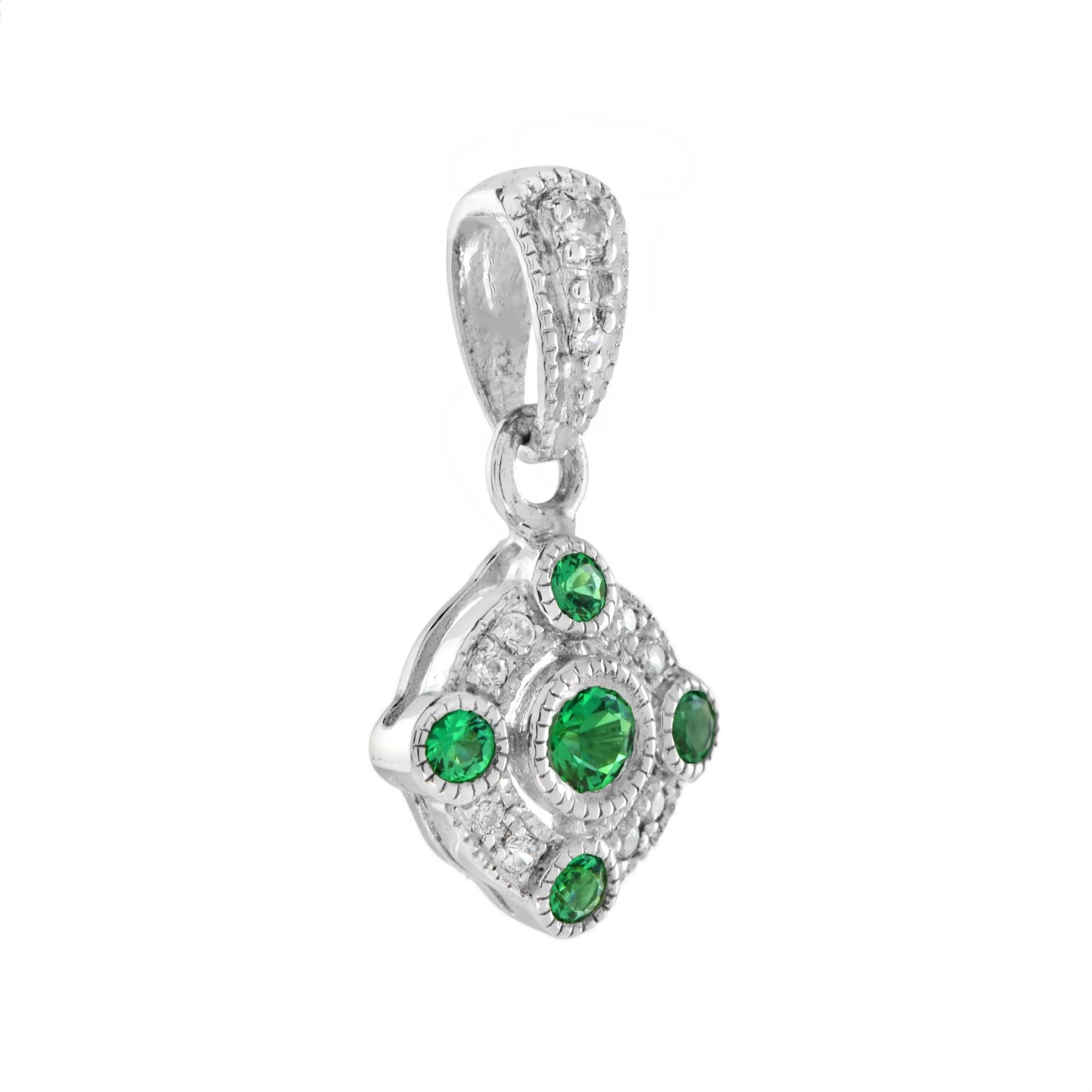 With pretty vintage styling, this pendant makes the perfect finishing touch to an outfit. Featuring five emeralds and ten round brilliant cut diamonds that give a subtle, glittering appearance. The edges of the design have millegrain detailing to