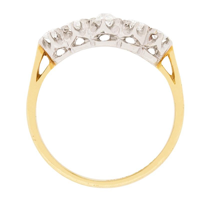 This two-tone, five stone diamond ring originated in the 1920s and it features a sparkling vintage quintet of old cut diamonds. The diamonds are graduated horizontally from the ring's centre and are hand-set in platinum claw illusion mountings