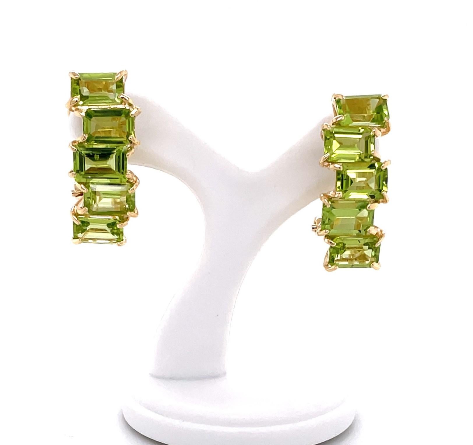 Ten vibrant lime green emerald-cut faceted .60 carat (4x6mm) peridot stones, 6.0 carats total weight, arranged in an abstract stack, create this lively pair of drop earrings.
In fourteen karat 14k yellow gold with post and omega clip, the earrings