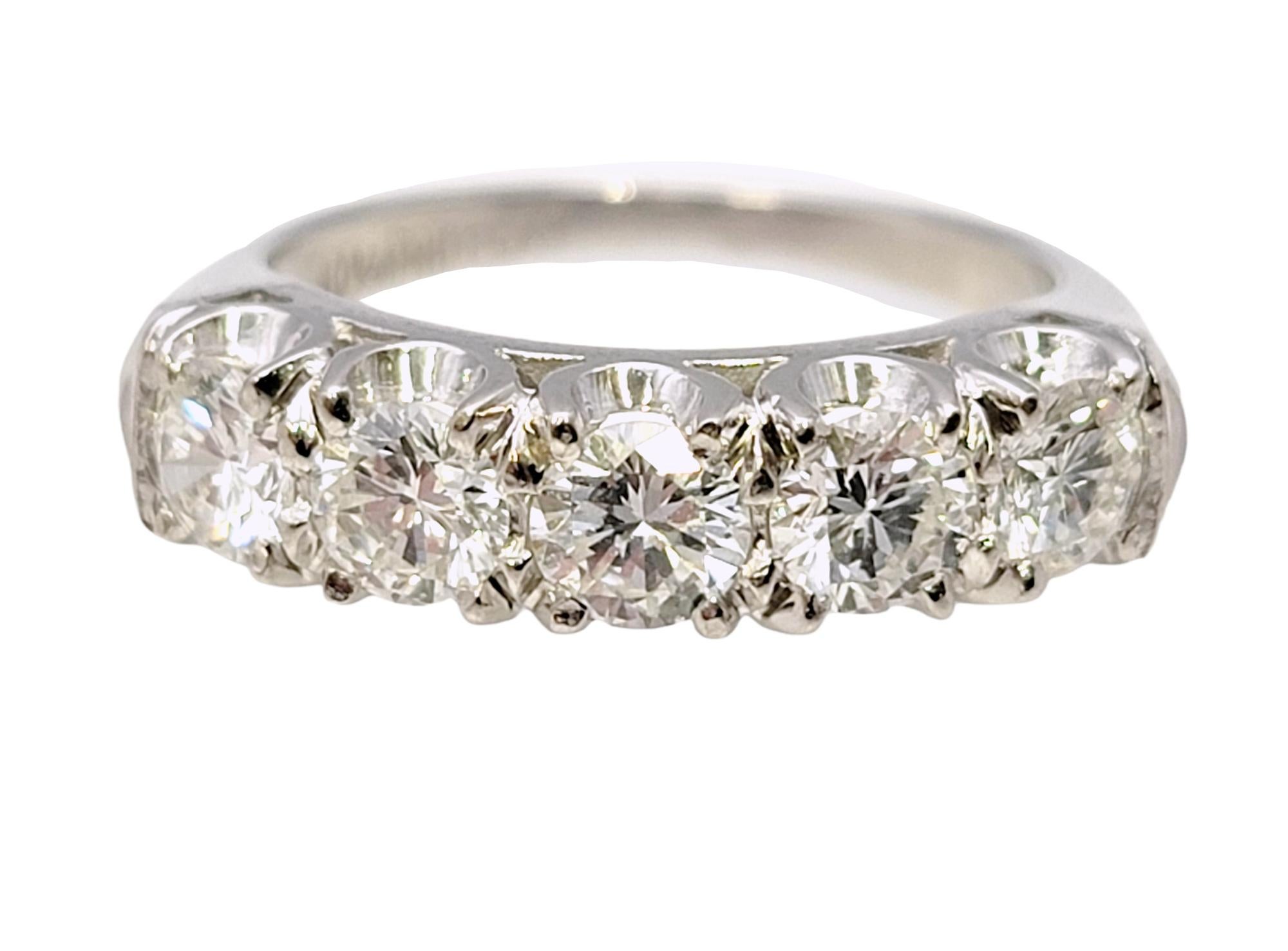 Ring size: 5.75

This gorgeous platinum and diamond band ring is a striking piece of jewelry. Along the ring, five exquisite stones are elegantly set, creating an impressive luxurious sparkle. This ring effortlessly combines modern style with