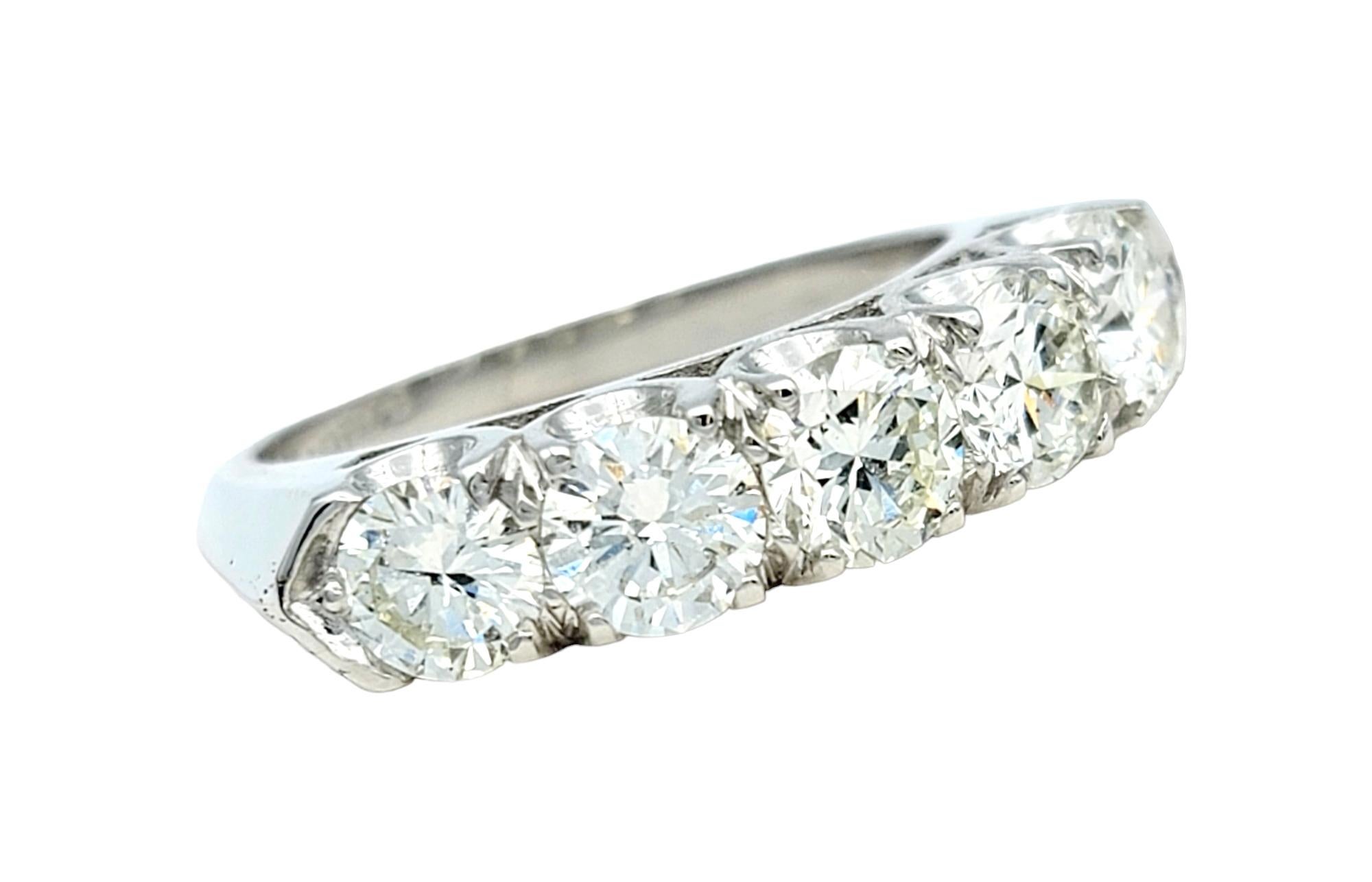 Ring size: 6

This gorgeous platinum and diamond band ring is a striking piece of jewelry. Along the ring, five exquisite stones are elegantly set, creating an impressive luxurious sparkle. This ring effortlessly combines modern style with timeless
