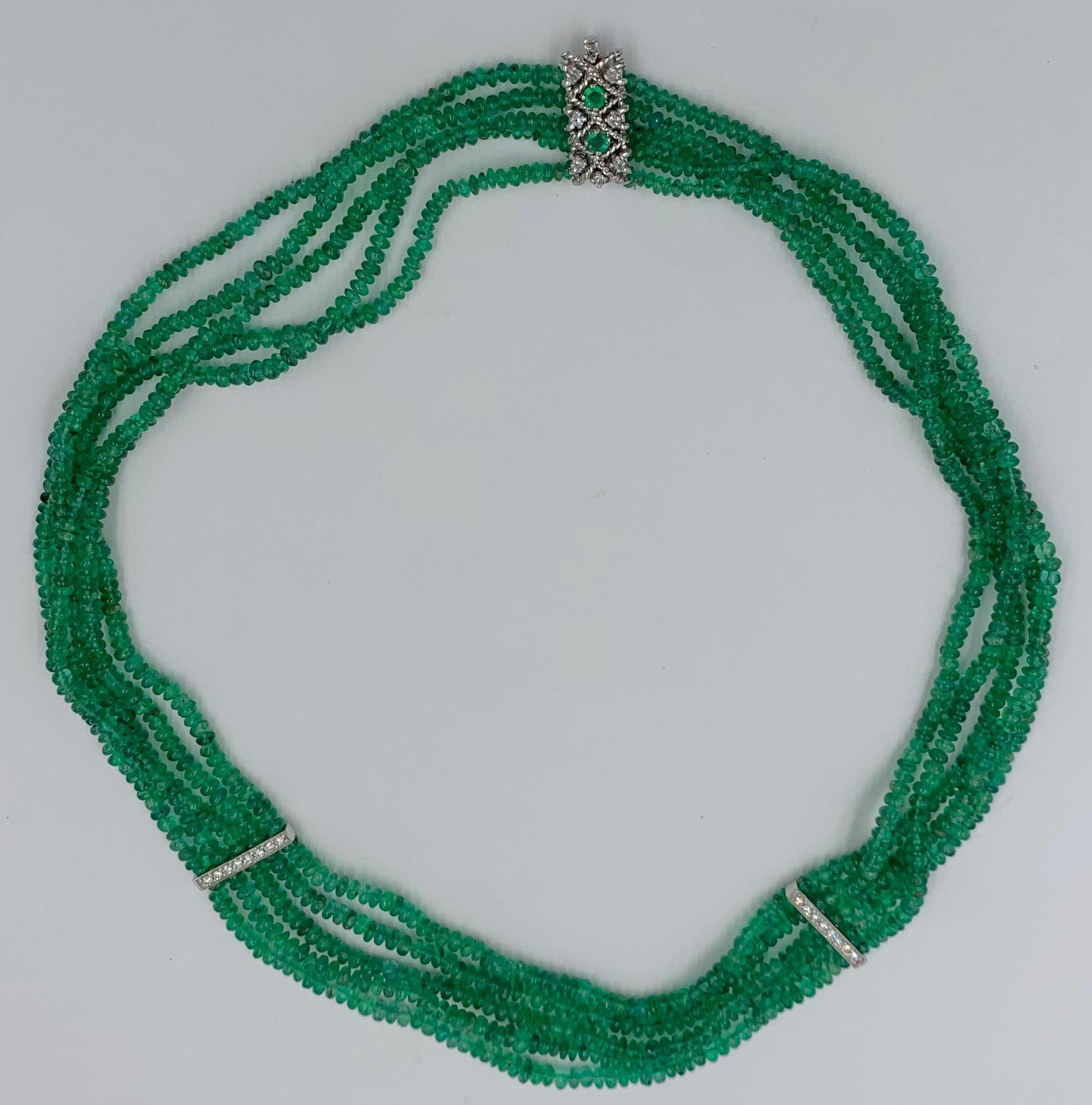 This is a radiant Emerald Diamond Necklace with Five Strands of Sparkling Natural Mined Emerald Beads with two stations of Diamonds joined by a roped Diamond and Emerald clasp in 14 Karat White Gold. The Emerald Necklace is 16.5 inches (42 cm) long.