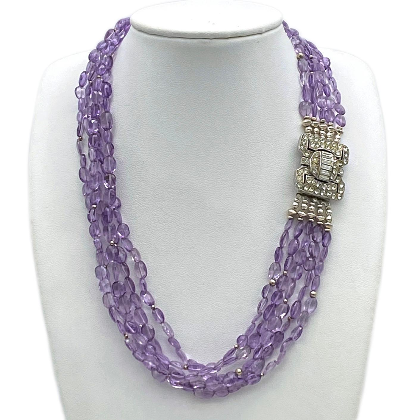 This is an Amethyst necklace with Art Deco clasp. We created this five-strand necklace with faceted amethyst translucent stones and sterling silver components. It features a vintage 1 x 1 x 0.5 inch Art Deco style clear rhinestone box clasp. Because