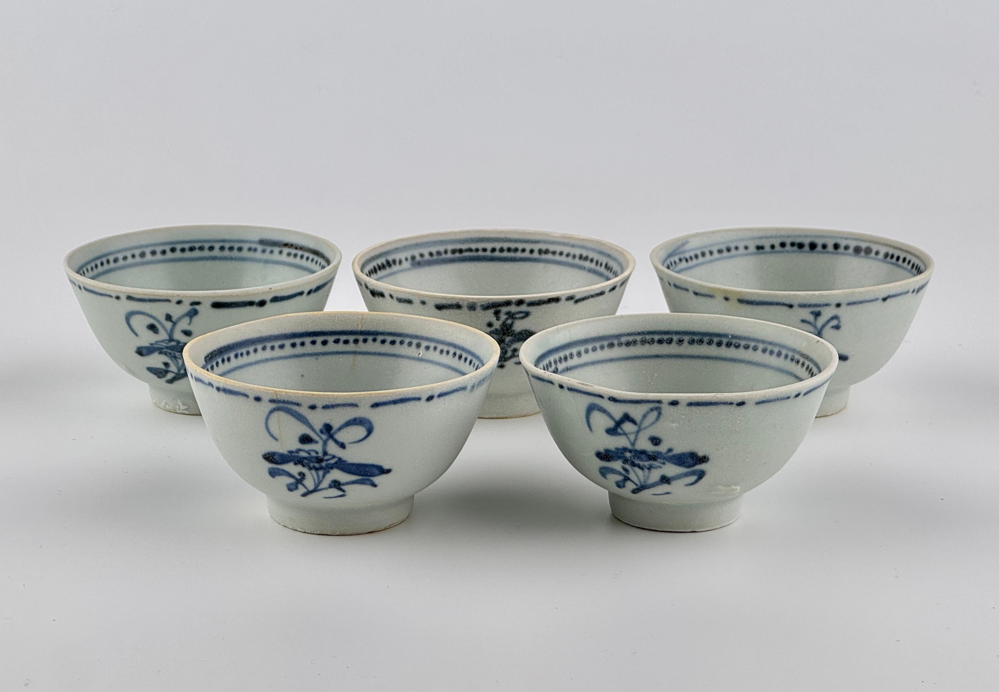 Five tea bowls, which have been salvaged from the Tek Sing, each decorated with aster sprays within a dot-dash line and featuring rims with a narrow band of dots between two parallel lines. The 