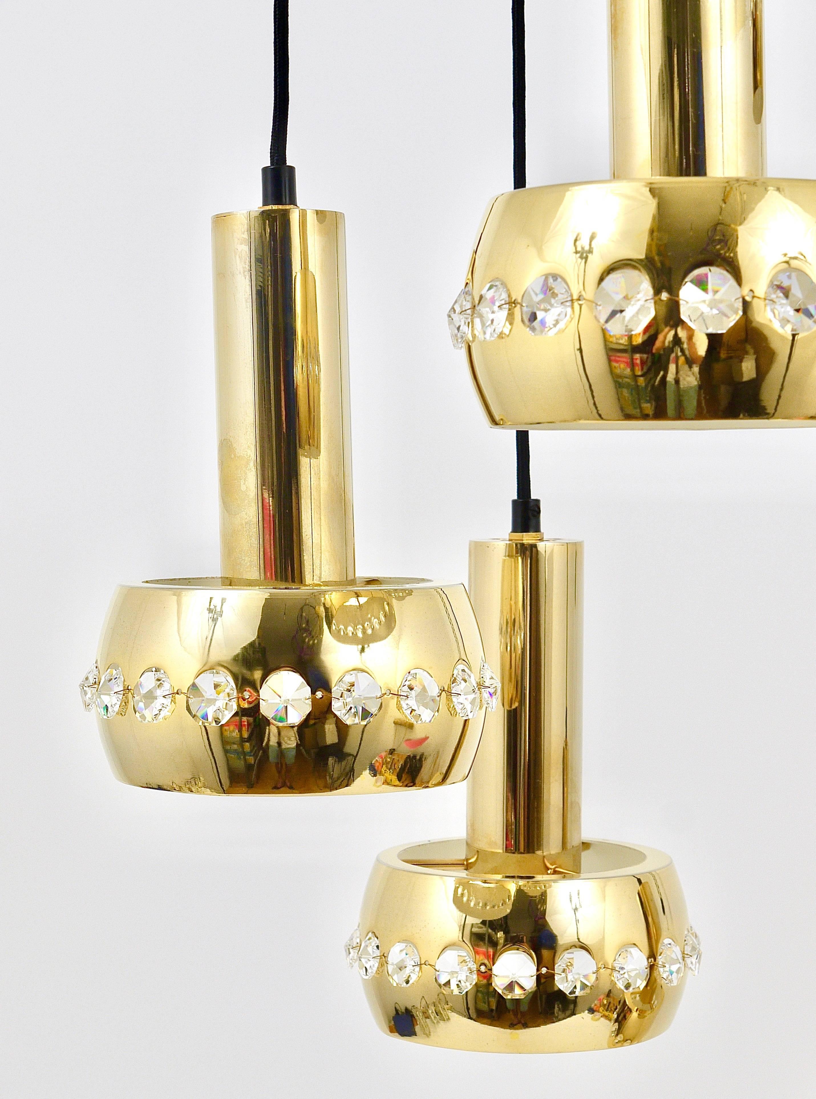 A beautiful brass five-arm cascading chandelier from the 1970s, designed an manufactured by Bakalowits & Söhne, Austria. Consisting of five lights, made of brass, the lampshades are covered with a row of diamond-shaped facetted crystals and hang on