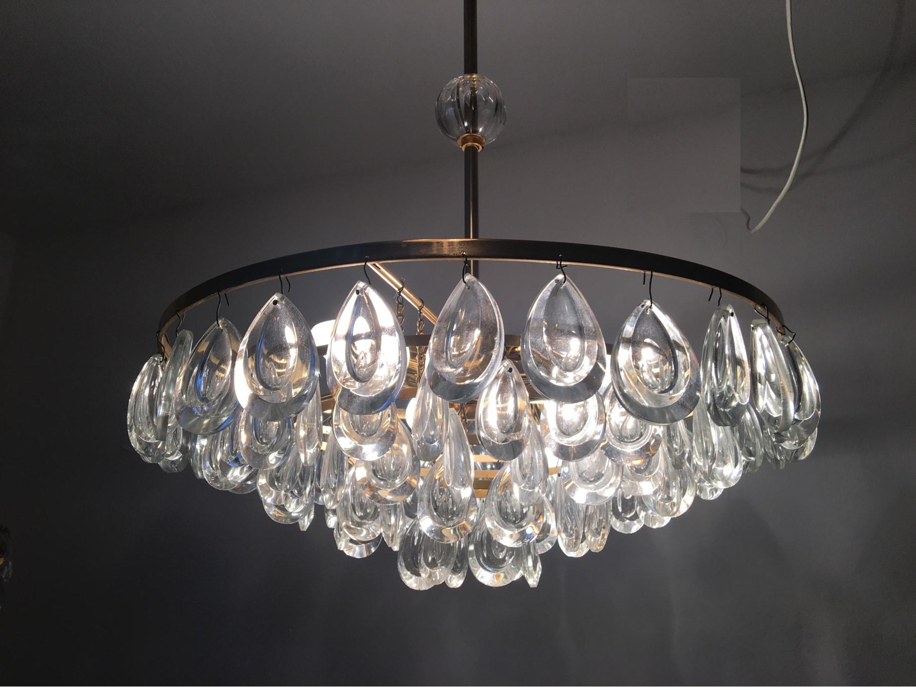A lovely crystal glass five-tiered drop chandelier by the famous Palwa manufacturer in Germany. In good, working condition. It requires four European E27 Edison bulbs and one E 14 candelabra bulb each up to 40 watts. It is equipped with original