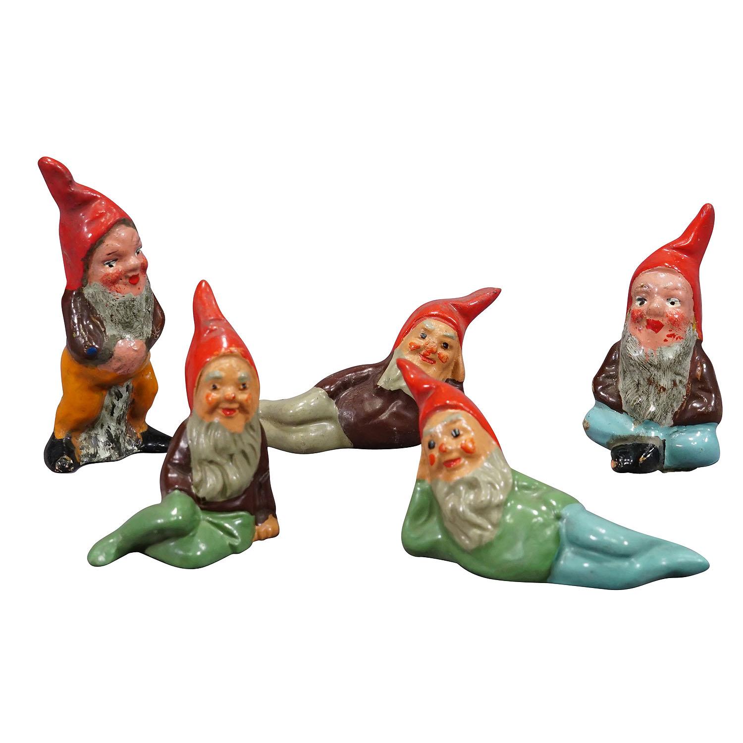 Five Tiny Terracotta Garden Gnomes, Germany ca. 1950s

A whimsy set of five tiny garden gnomes made in Germany ca. 1950s probably by Heissner. They are made of terracotta and hand-painted with bright colors. Good used vintage condition with signs of