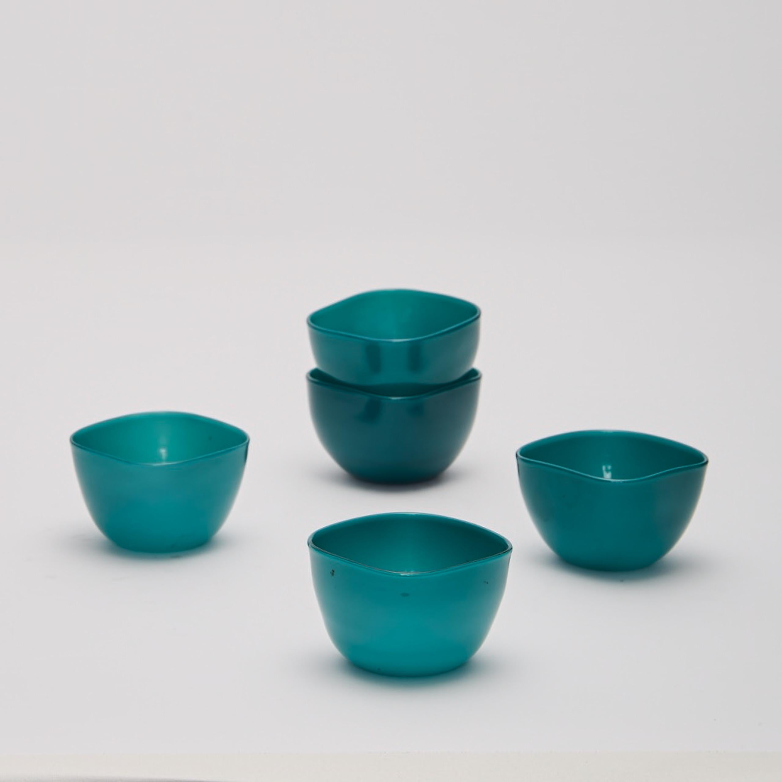 Five small turquoise opaline hand blown bowls by Paolo Venini (1895-1959) circa 1950 for Venini, opaque glass, acid stamp to each 'Venini Murano Italia'.
Dimensons; each height 1 1/2 in (4 cm); width 2 1/6 in (6 cm).

